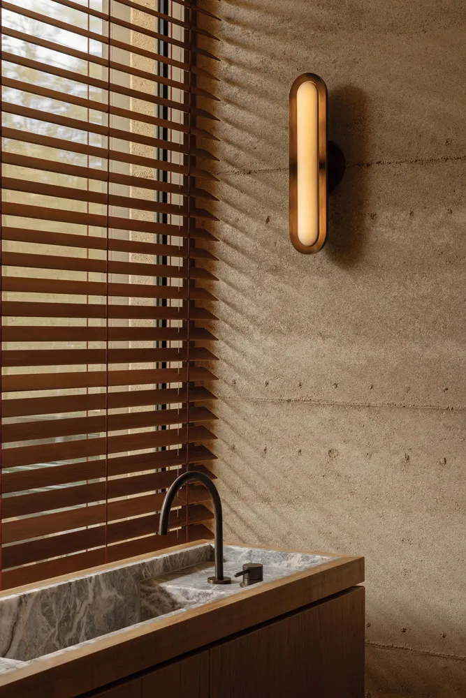 Bathroom with a marble sink, a window, and bathroom essentials, featuring a clean and organized atmosphere