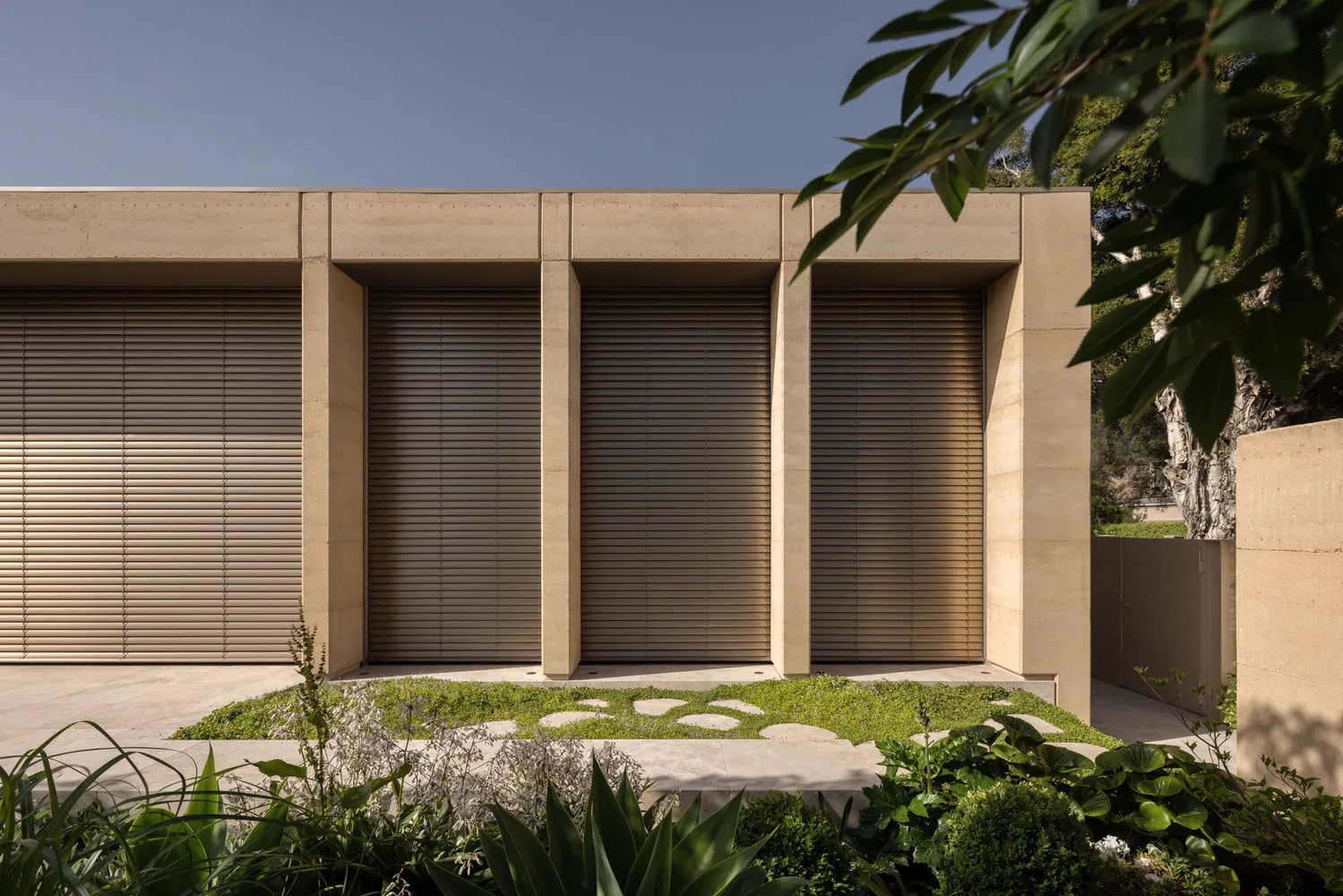 Modern building with large windows, concrete, glass, and wood materials, featuring ample natural light and a functional design