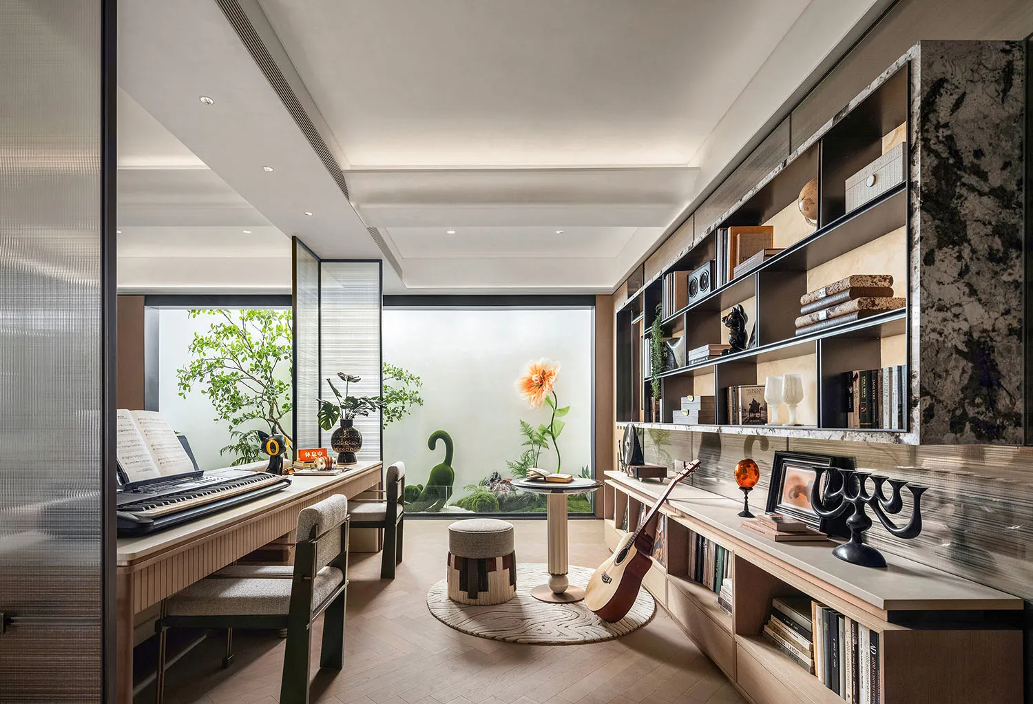 Cozy living room with hardwood floors, white walls, and a piano, featuring furniture, books, and potted plants, well-lit and inviting
