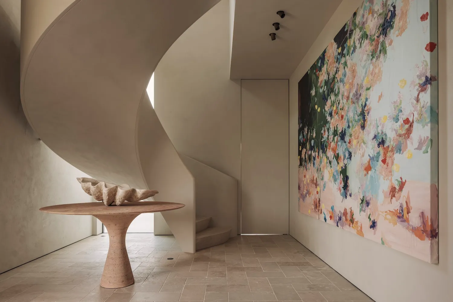 A minimalist spiral staircase in a home, with a top-down view and no other objects or elements present