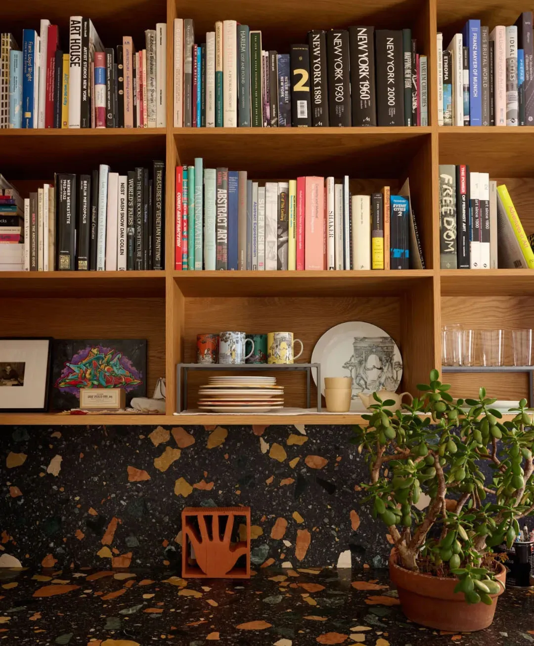 A wooden bookshelf filled with various books, arranged in an organized manner, creating a cozy and inviting atmosphere in a personal library or reading nook