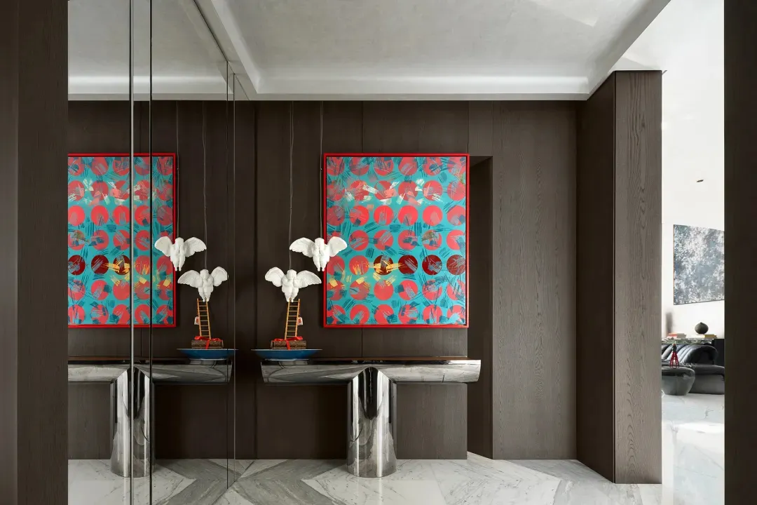 Double sink bathroom with vases of flowers, well-lit, and elegant decor