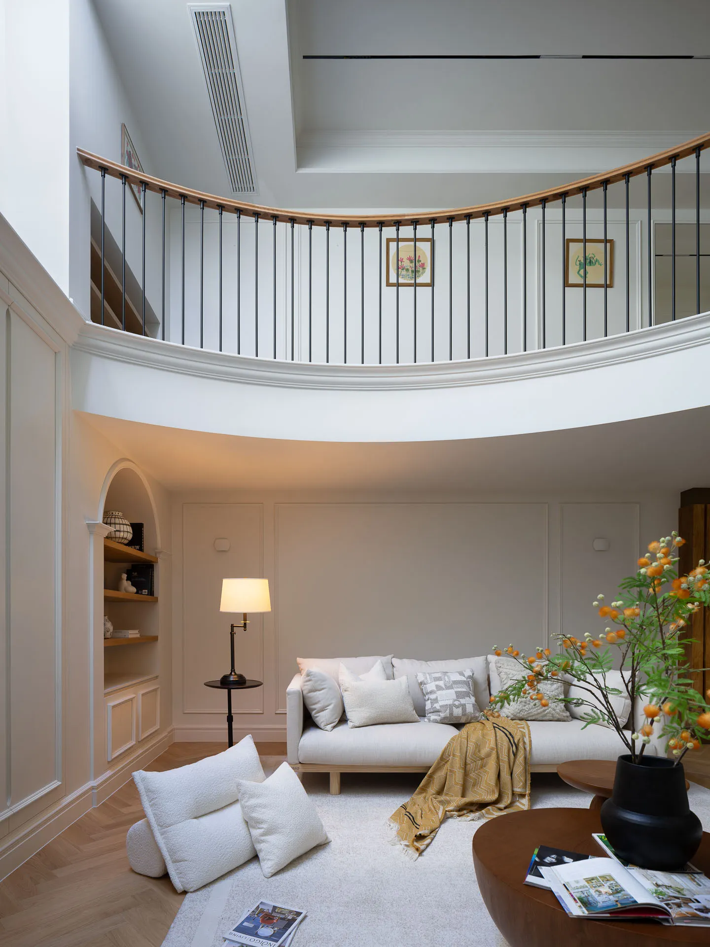 A bright and inviting open concept living area with a white couch, two chairs, a dining table, and a potted plant, emphasizing comfort and functionality