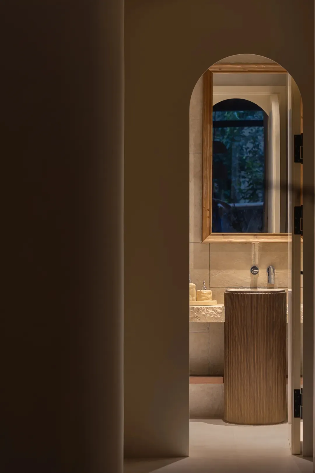 Bathroom with two sinks, a wooden cabinet, and tile walls, featuring a modern design and clean aesthetic