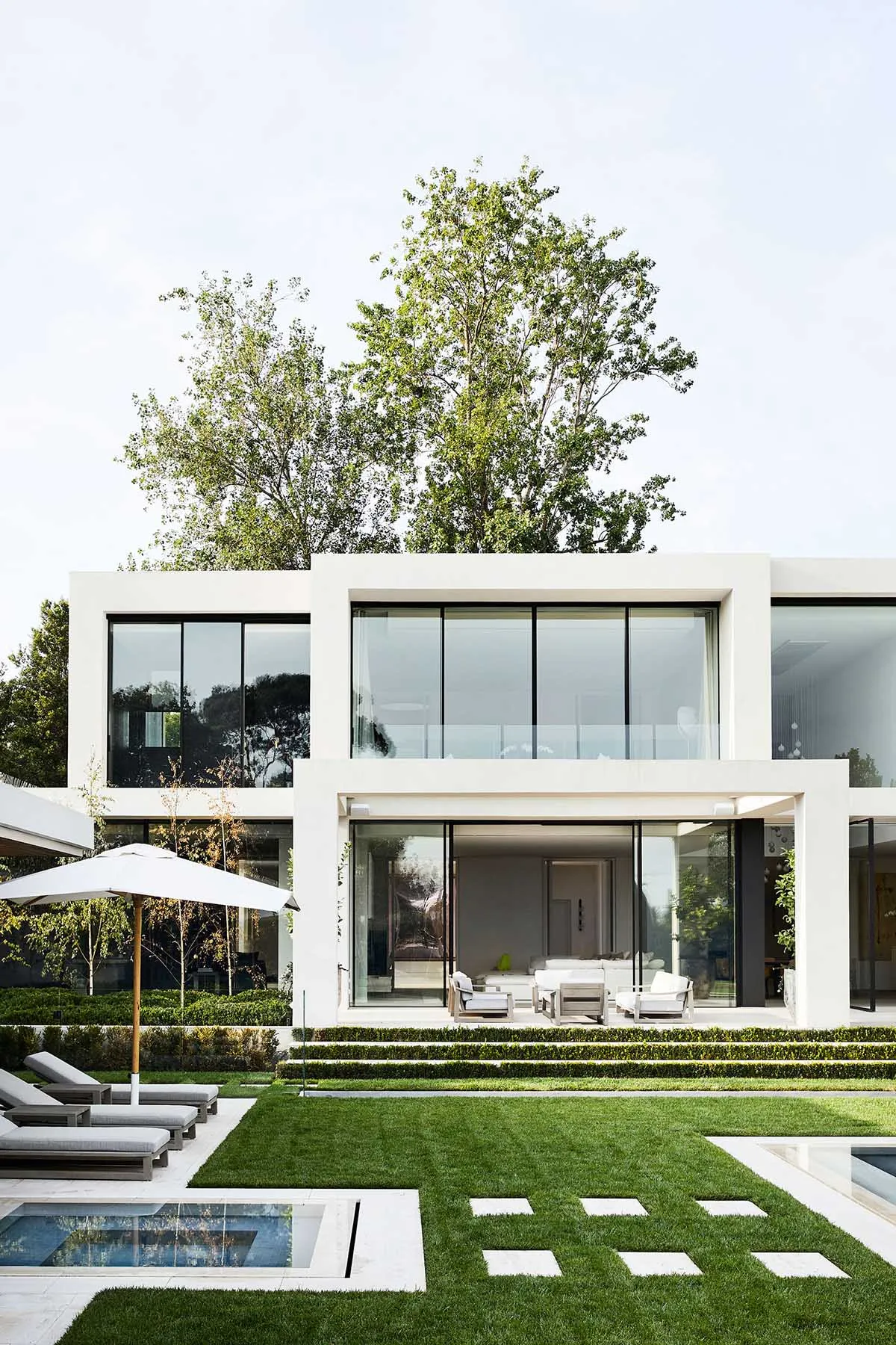 A modern living area with a patio featuring multiple seating options, clean lines, and a focus on functionality and comfort
