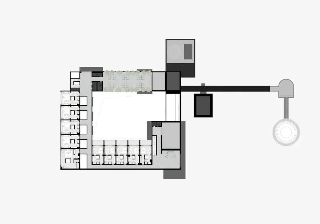 Large modern building floor plan with room outlines, labels, measurements, and symbols, featuring a white building with concrete and steel materials
