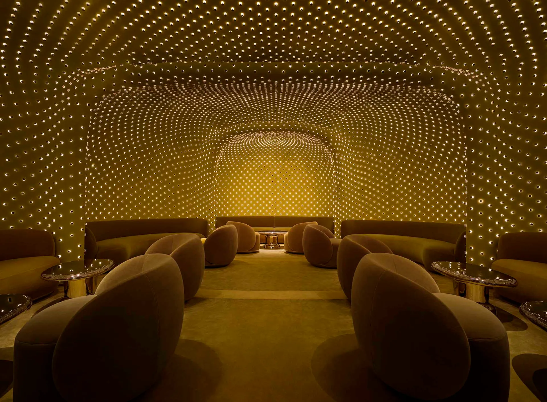 A warm and inviting room with a yellow ceiling and walls, featuring various seating options and a comfortable atmosphere