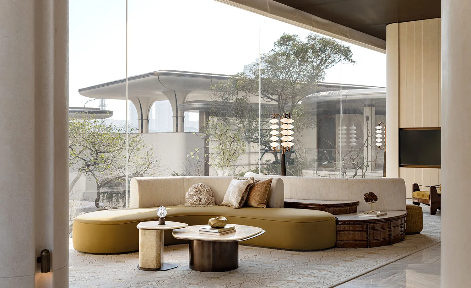 A well-lit living room with a large couch, coffee table, and various decorative items, creating a cozy and inviting atmosphere