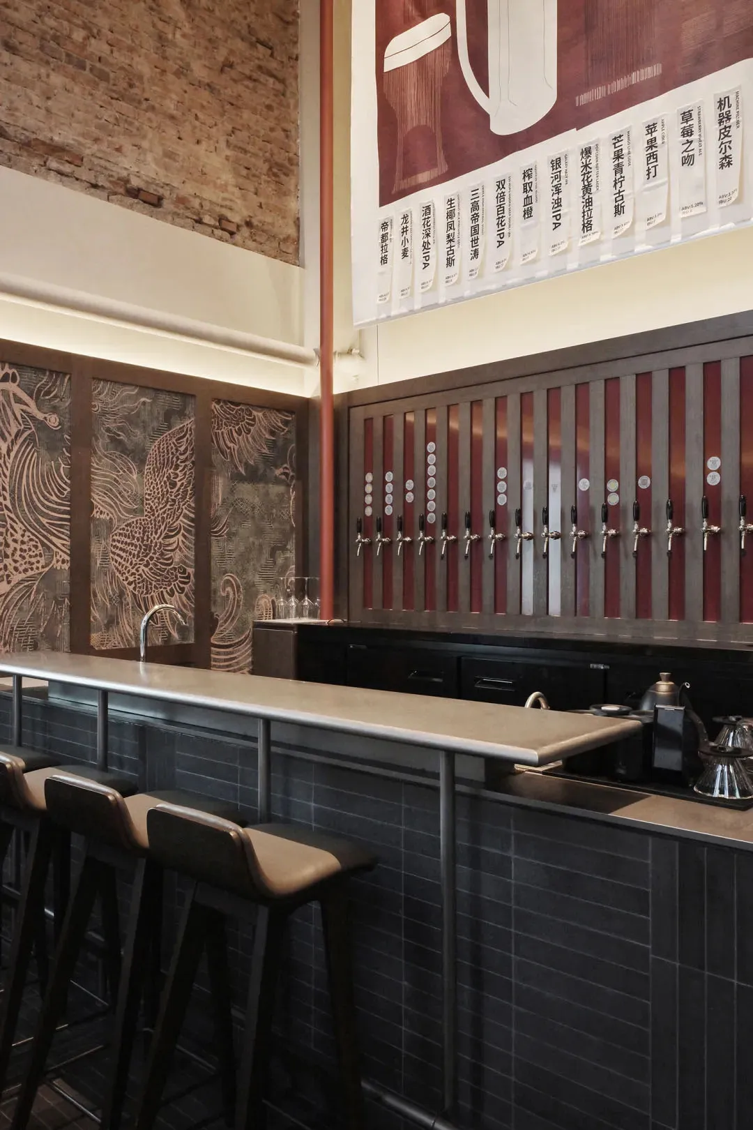 A modern bar with a metal counter, multiple beer taps, and comfortable seating, set in a well-lit atmosphere