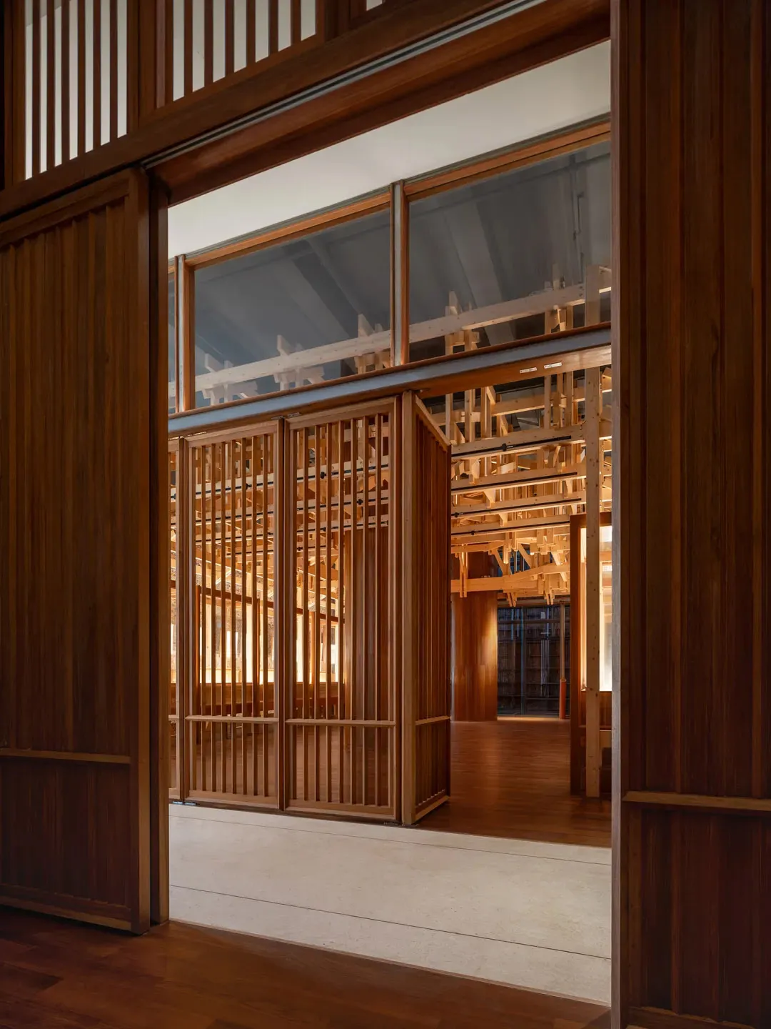 A dimly lit room with wooden walls and floor, creating a warm and intimate atmosphere