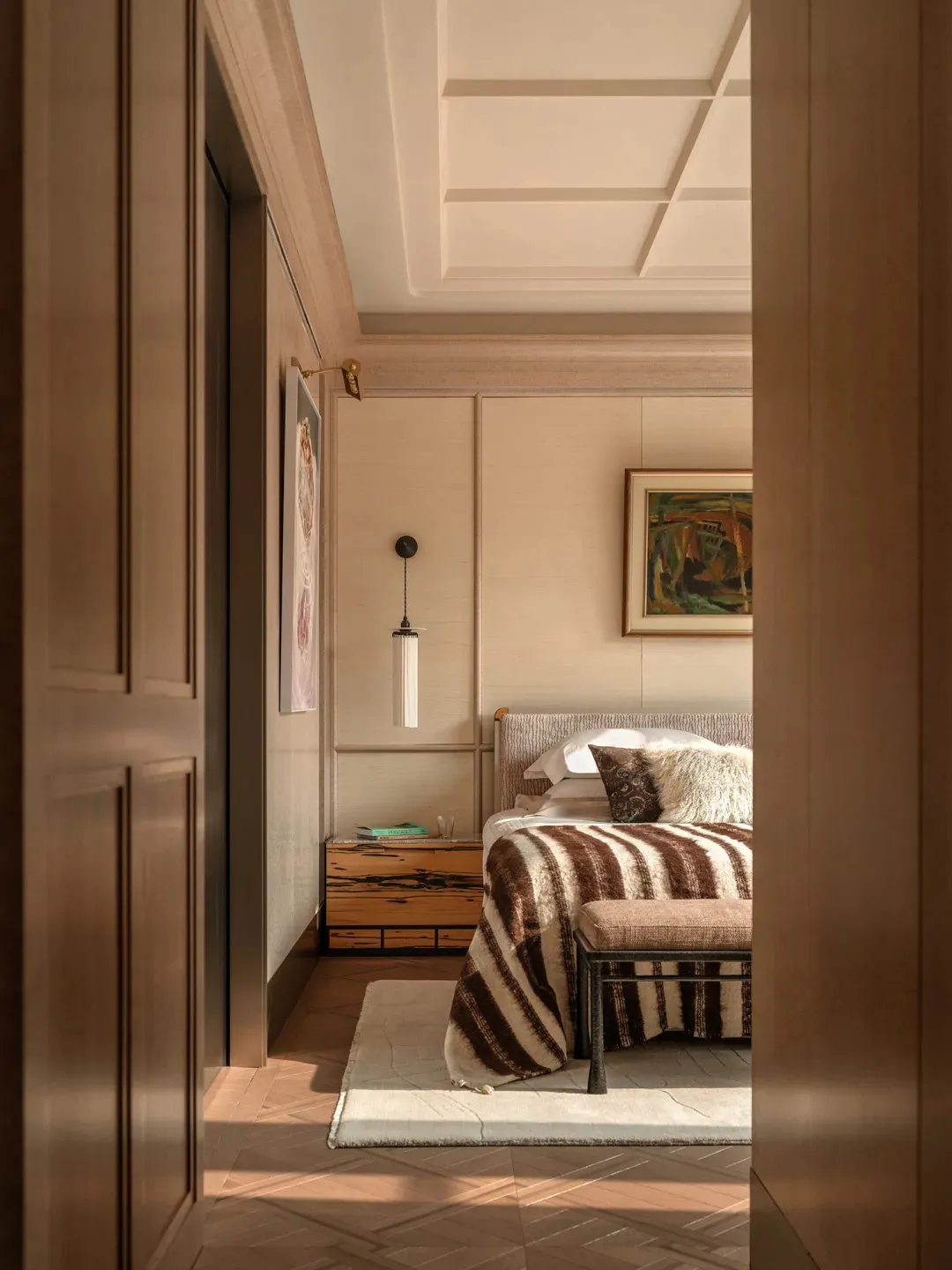 Wooden bedroom with a bed, chair, and couch, warm and cozy atmosphere, natural lighting