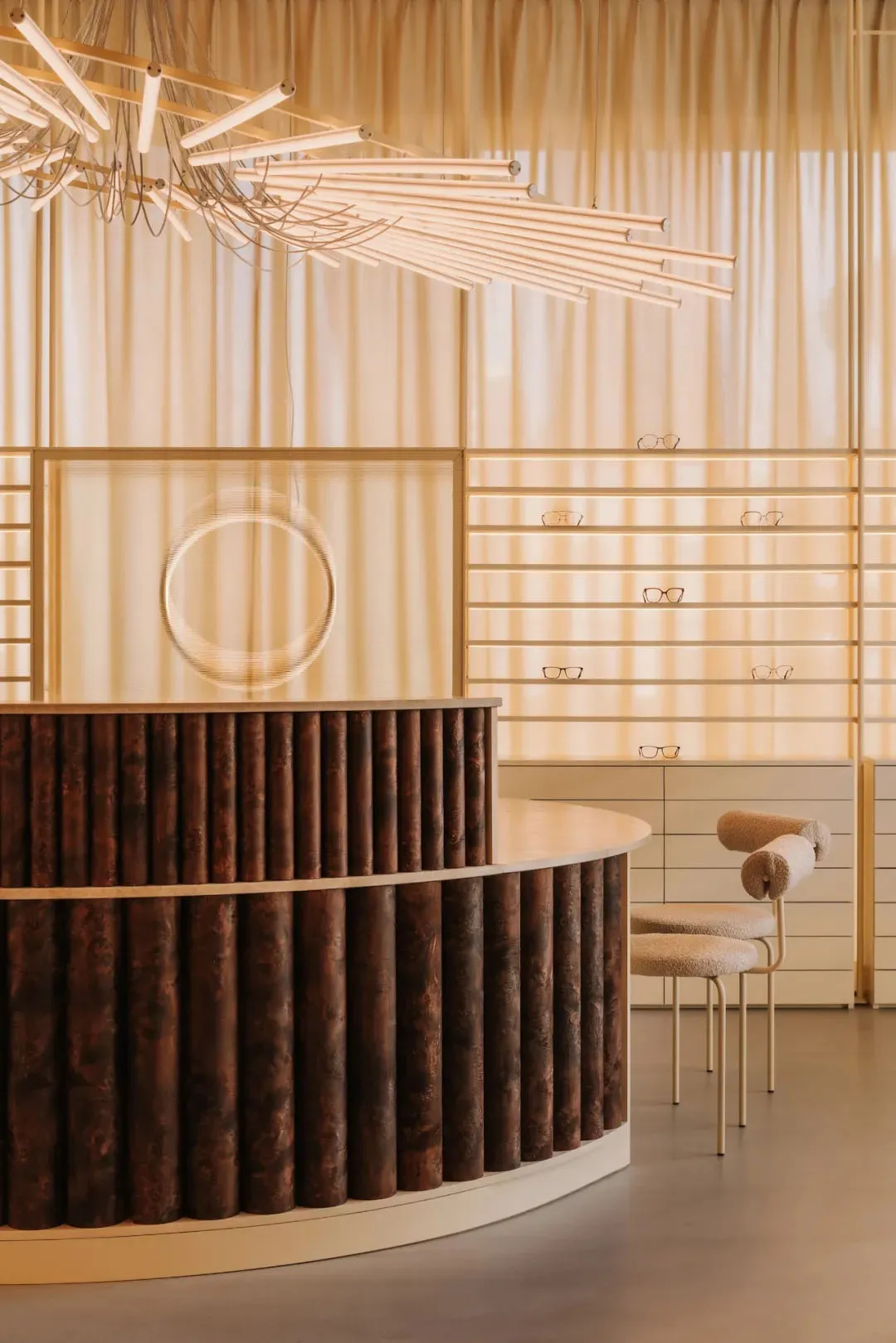 A store or showroom with a wooden counter and pendant light fixture, creating a warm and inviting atmosphere