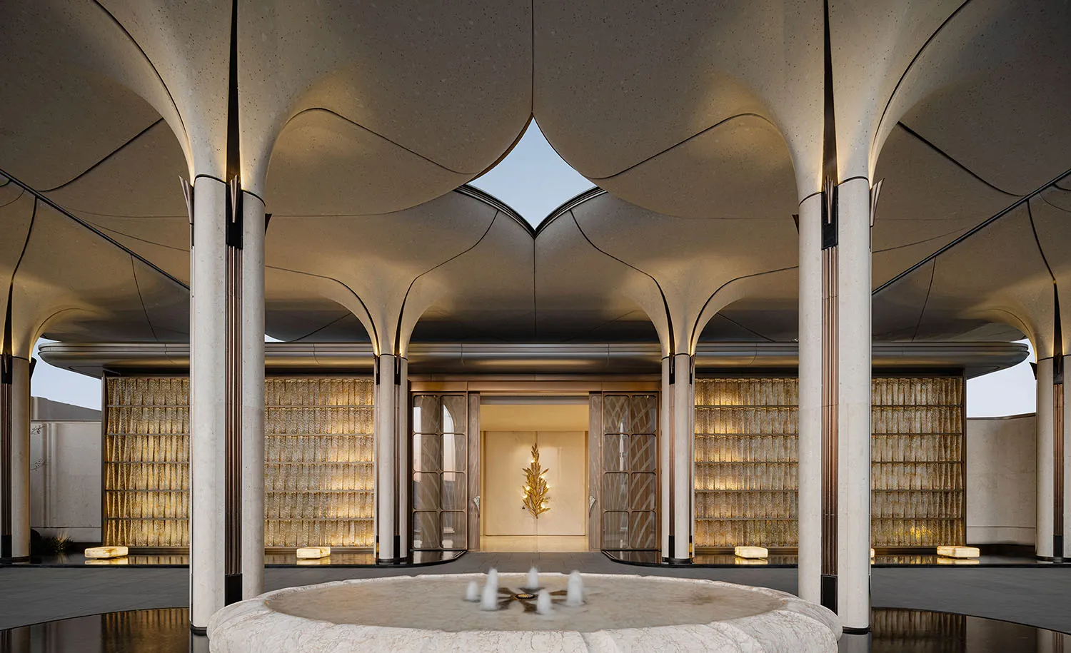 A modern lobby with a circular pool, white surfaces, and natural light from windows, featuring comfortable seating and a clean design