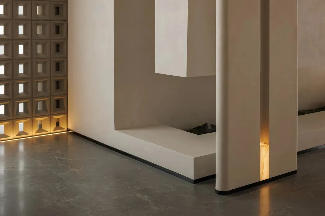 Cozy living space with a white bench, dim lighting, and modern design