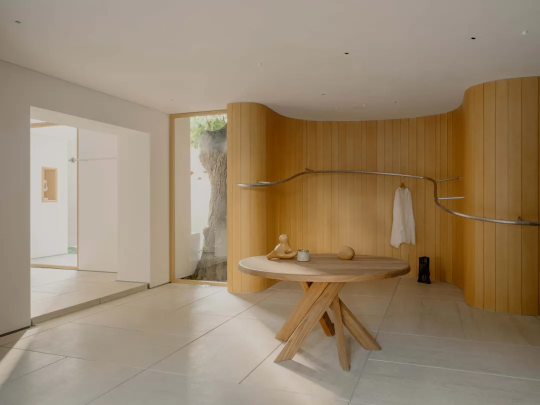 Bathroom with a wooden floor, table, and dim lighting creating a cozy atmosphere
