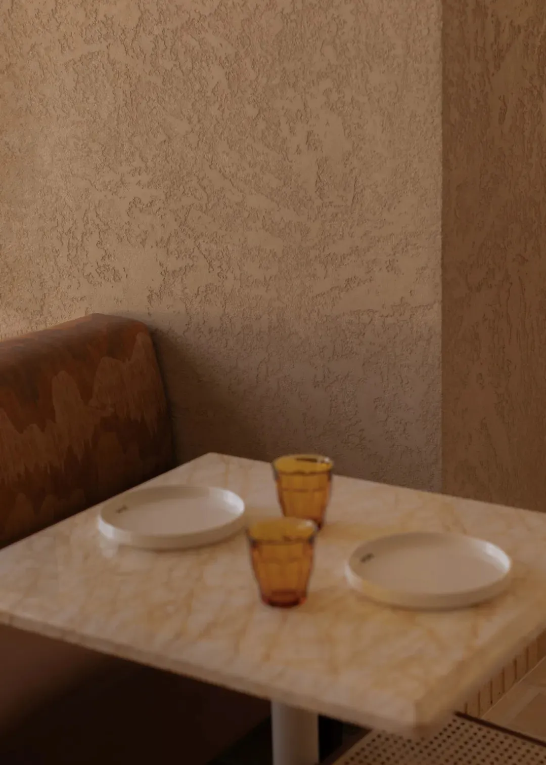 Dining room with a table and chairs, set with plates and glasses, surrounded by a cozy and inviting space with a patterned wall and soft warm lighting