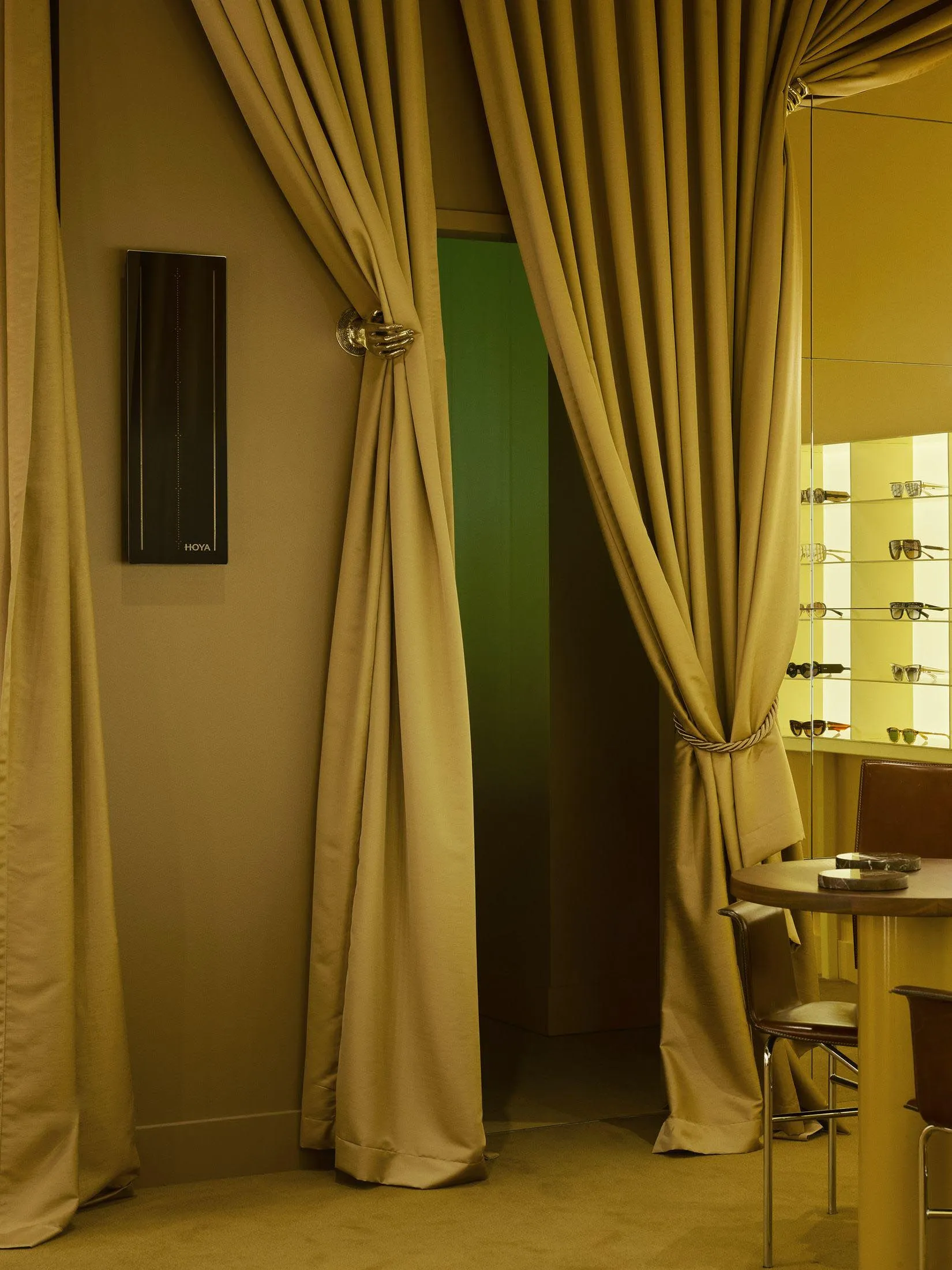 A yellow-colored dining room with a table, chairs, mirror, and doorway, creating a warm and inviting atmosphere