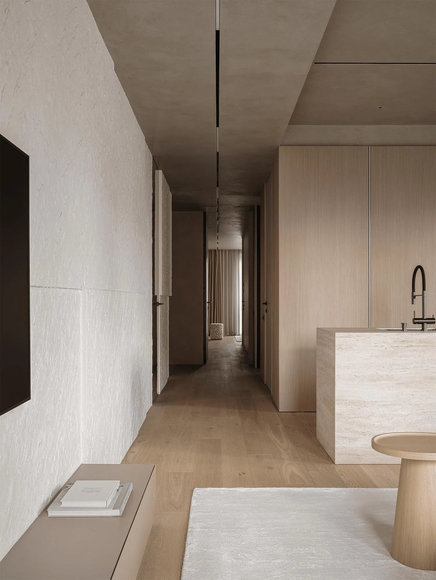 A modern bathroom with white walls, wooden floors, and natural light, featuring a sink, toilet, and dining table