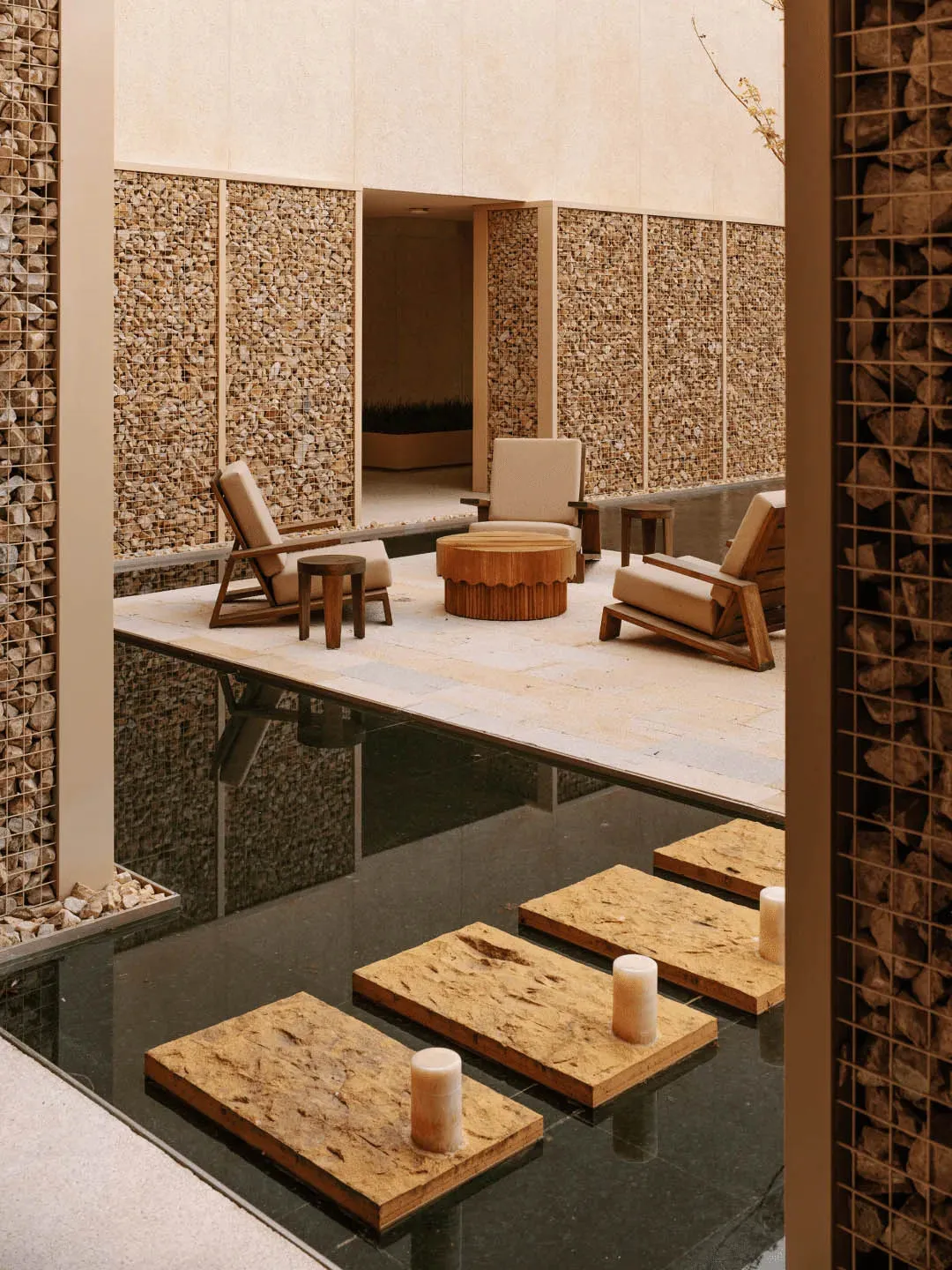 Cozy living space with stone floor, walls, and furniture, featuring a warm and inviting atmosphere