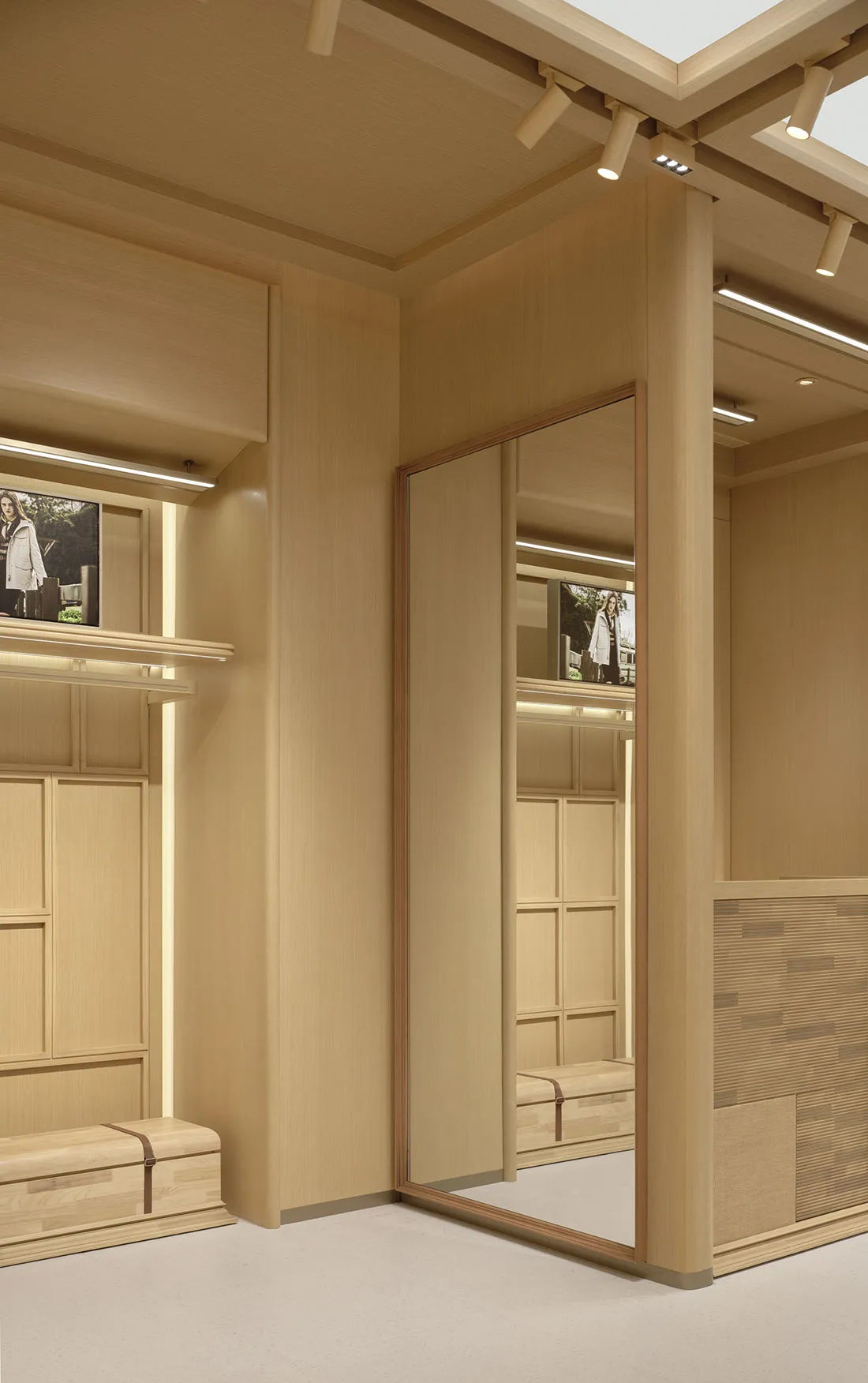 Wooden dressing room with a large mirror, a bench, and a chair, creating a warm and cozy atmosphere