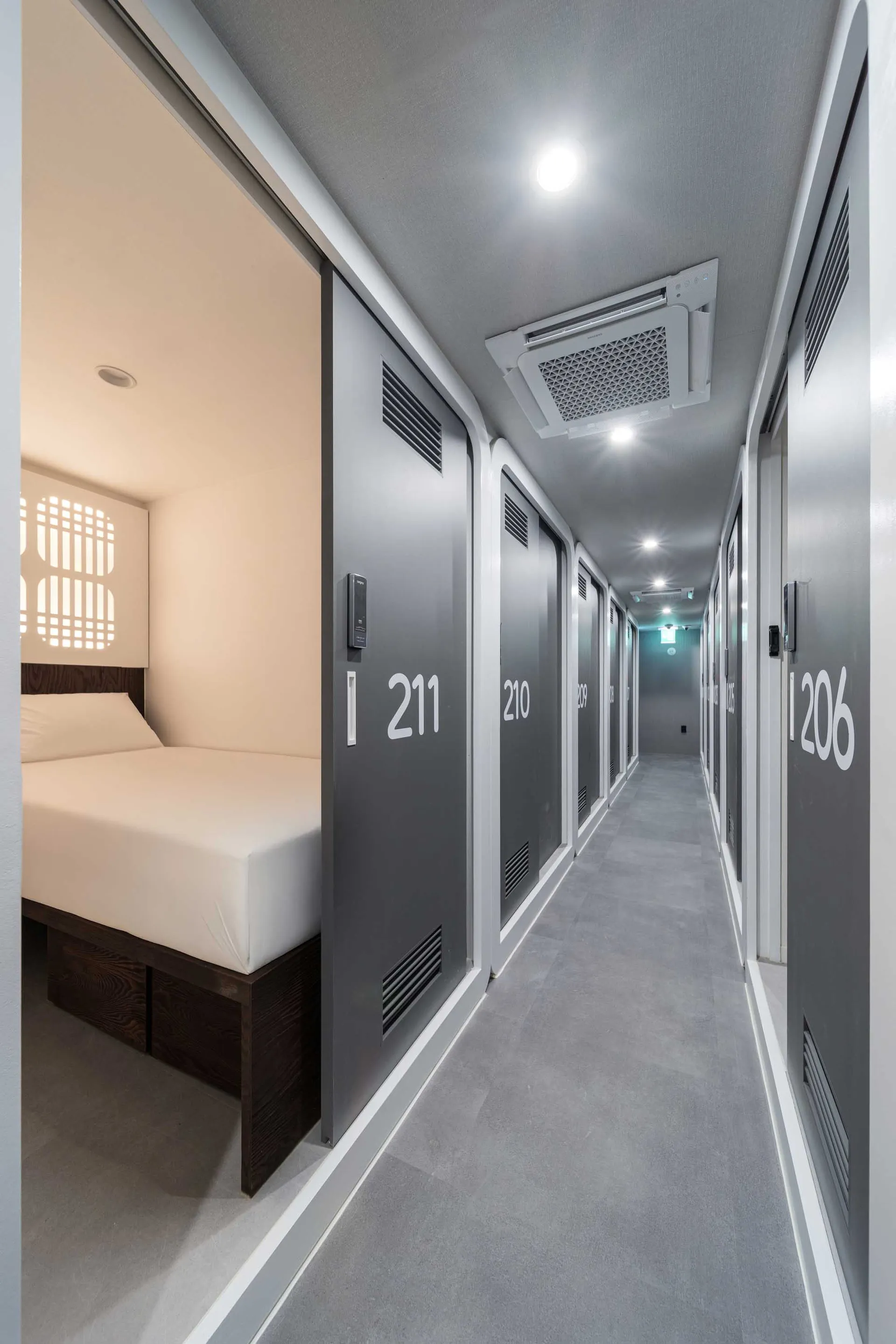 Gray hotel room floor plan with a bed on the left, a desk in the center, and a closet on the right