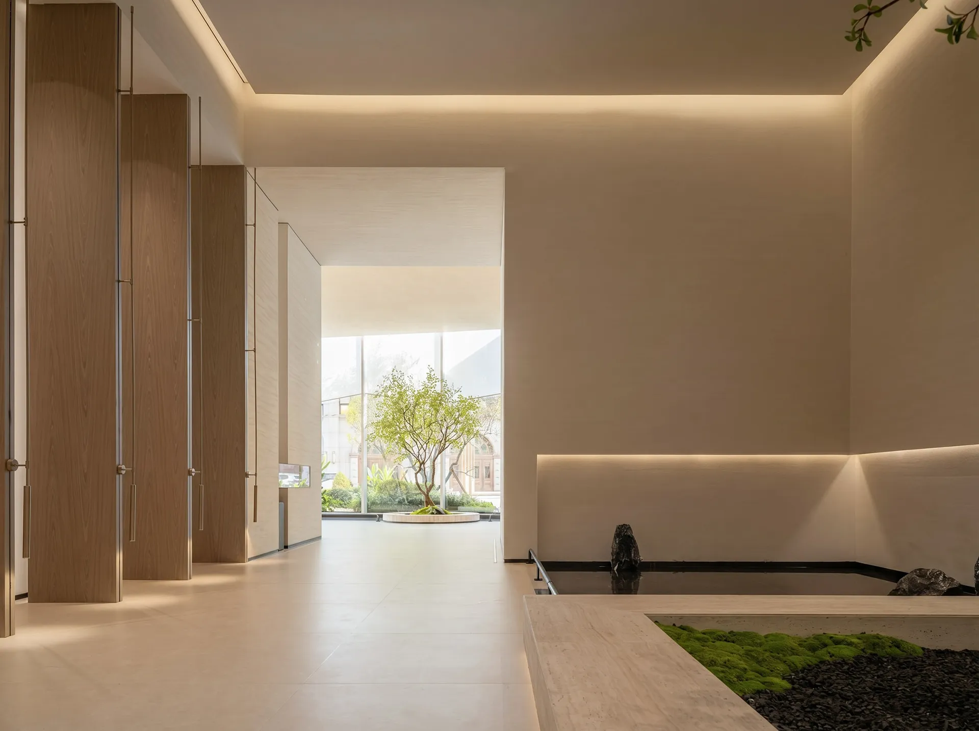 A bright and inviting open-plan living space with a white color scheme, natural light, and a dining table and chairs