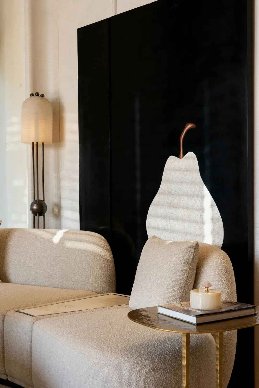 Cozy living room with a black and white color scheme, featuring a couch and chair in a comfortable and inviting arrangement, with soft and diffused lighting