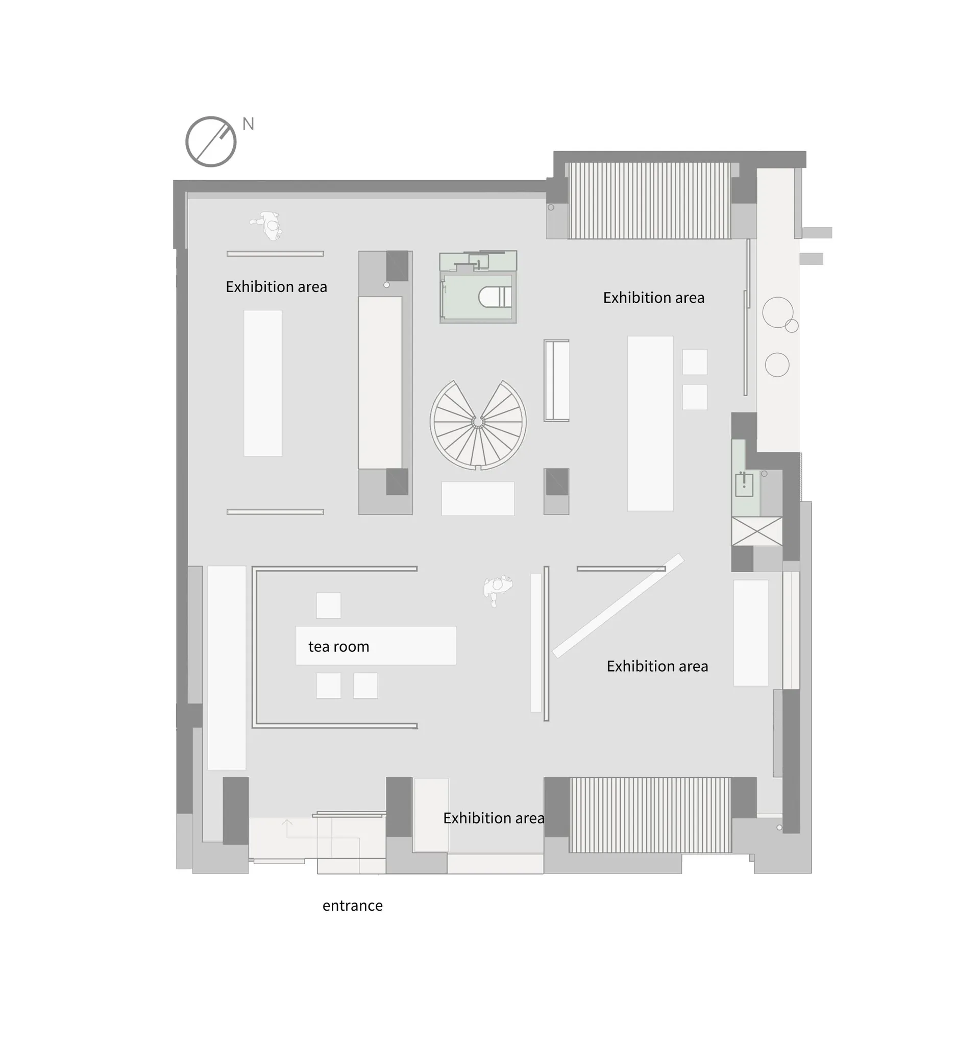 White and black floor plan of a modern building with multiple rooms and a central lobby or exhibition space, featuring clean lines and a focus on functionality