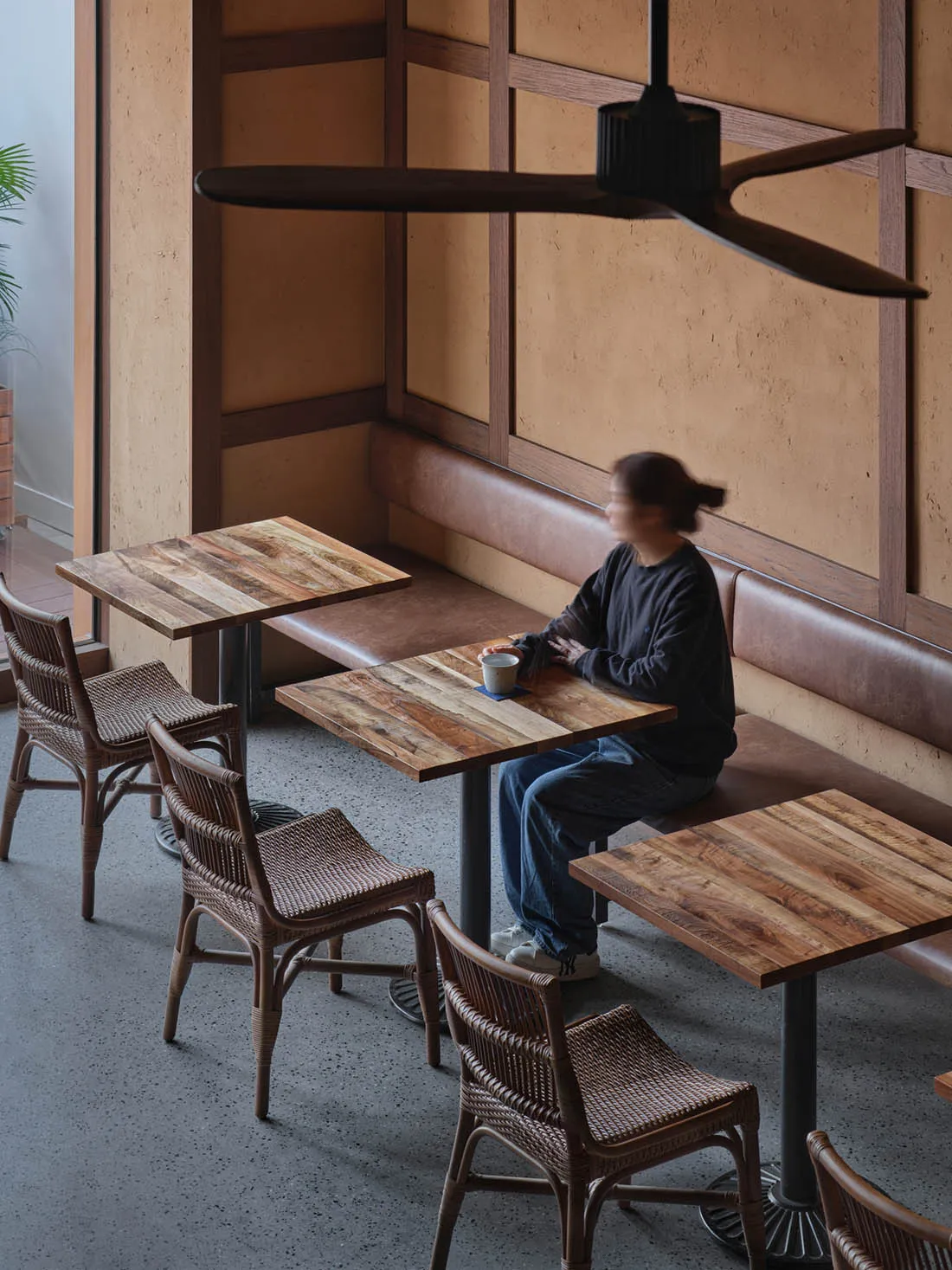 Cozy restaurant with a wooden dining table, brick elements, and soft warm lighting