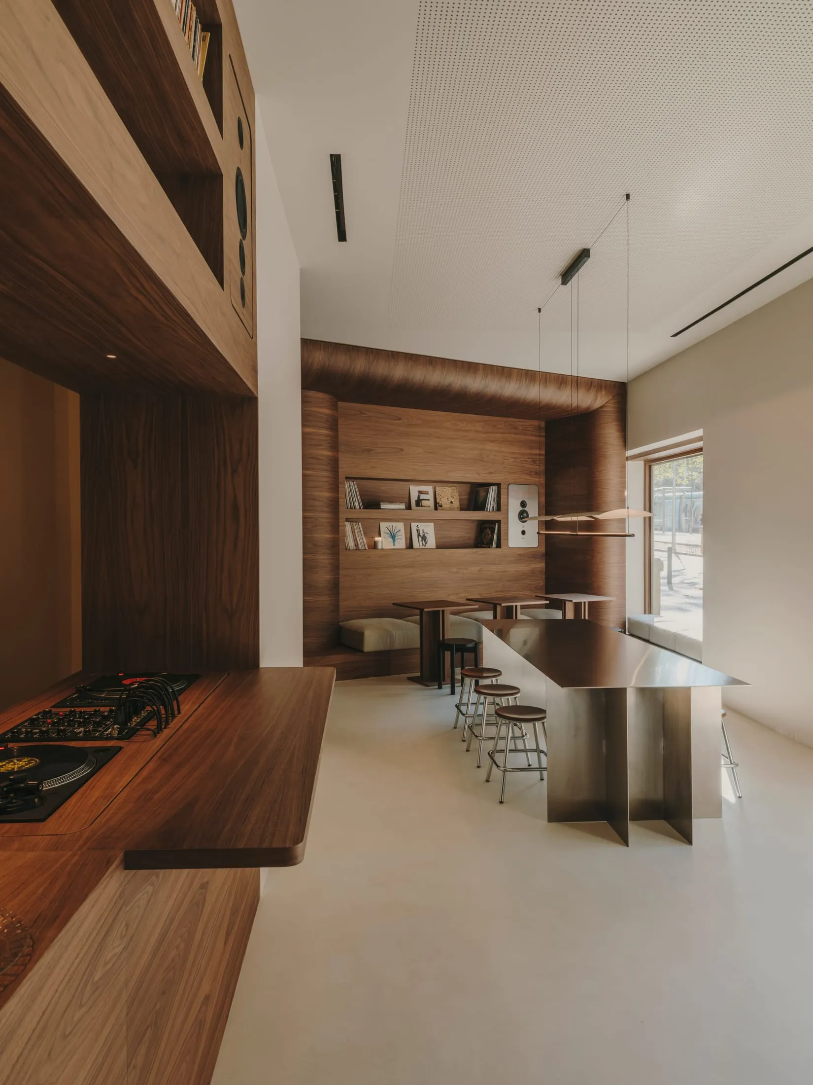 Warm and inviting kitchen and dining area with wooden cabinets, a wooden countertop, and a dining table surrounded by chairs