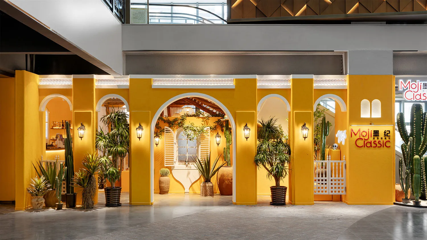 A brightly lit room with a yellow color scheme, featuring potted palm trees, vases, and bowls, creating a warm and inviting atmosphere