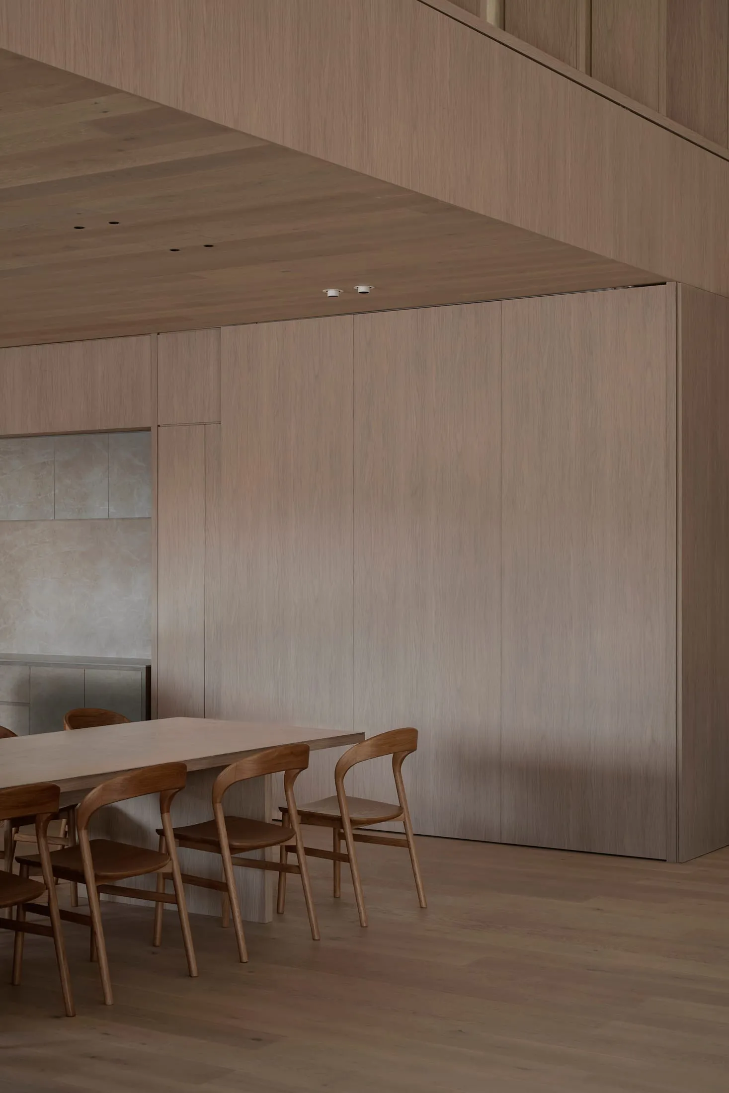 Dining room with wooden walls and table, wooden chairs, and a warm inviting atmosphere