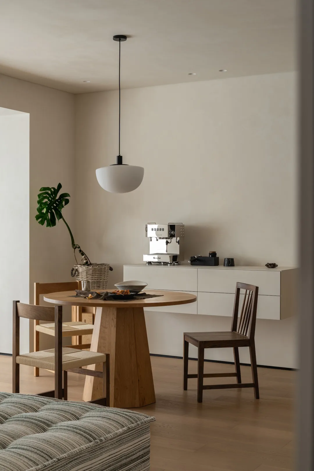 A warm and inviting dining area with a wooden table and chairs, surrounded by a kitchenette in the background