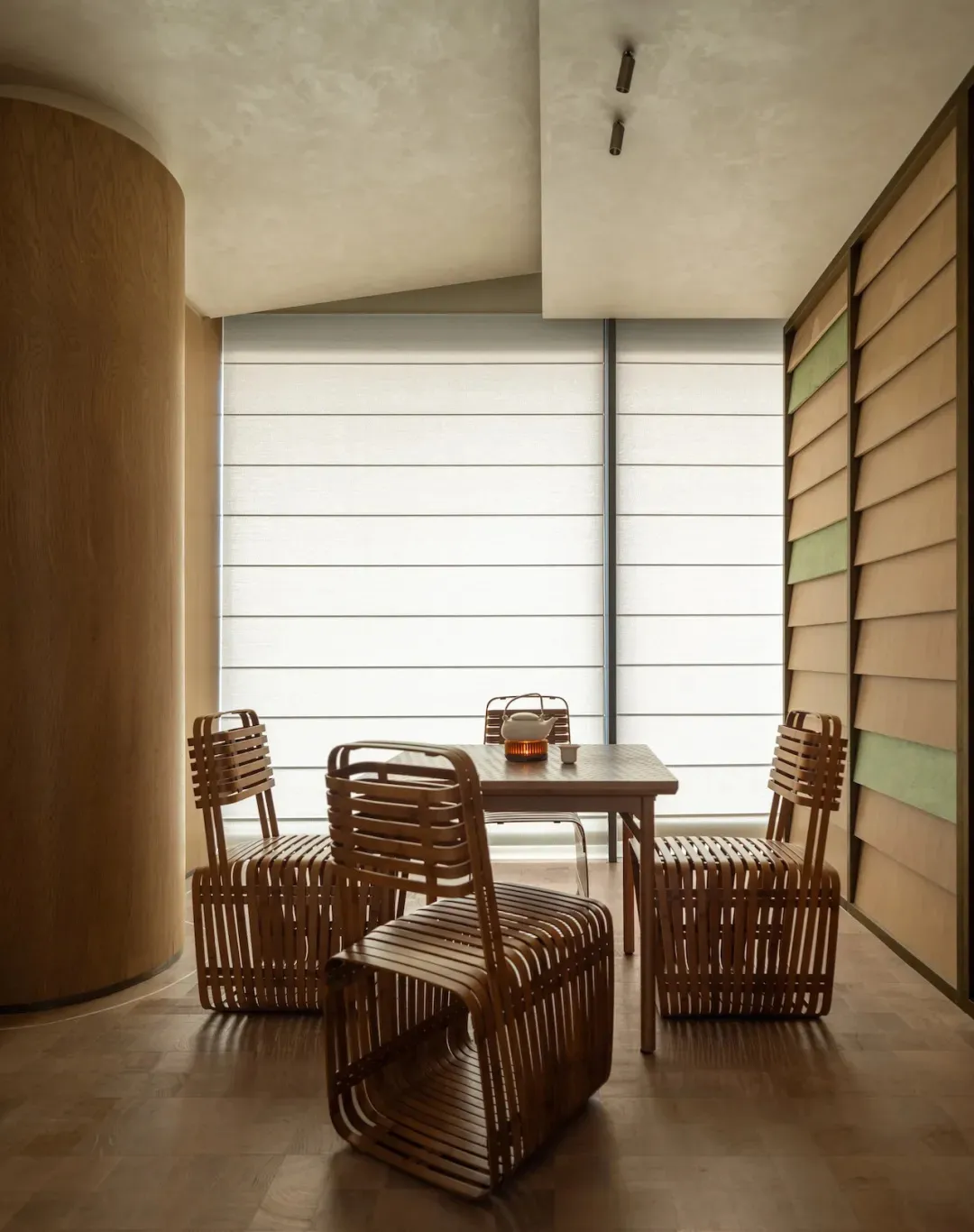 Cozy dining room with a wooden floor, a wicker and wood table, and dim lighting