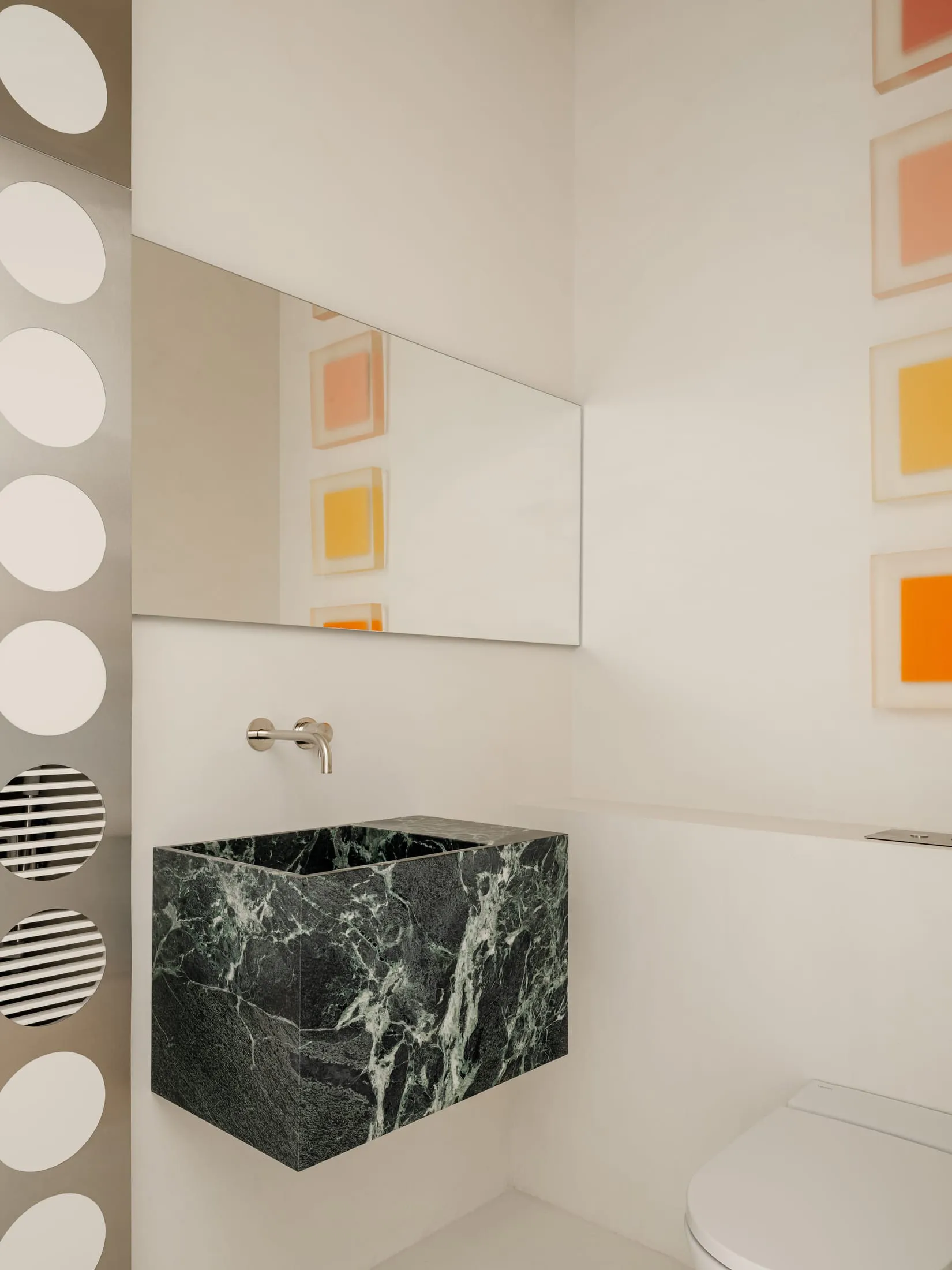 Bright and inviting bathroom with a modern sink, mirror, and marble countertop, featuring clean lines and minimalistic design