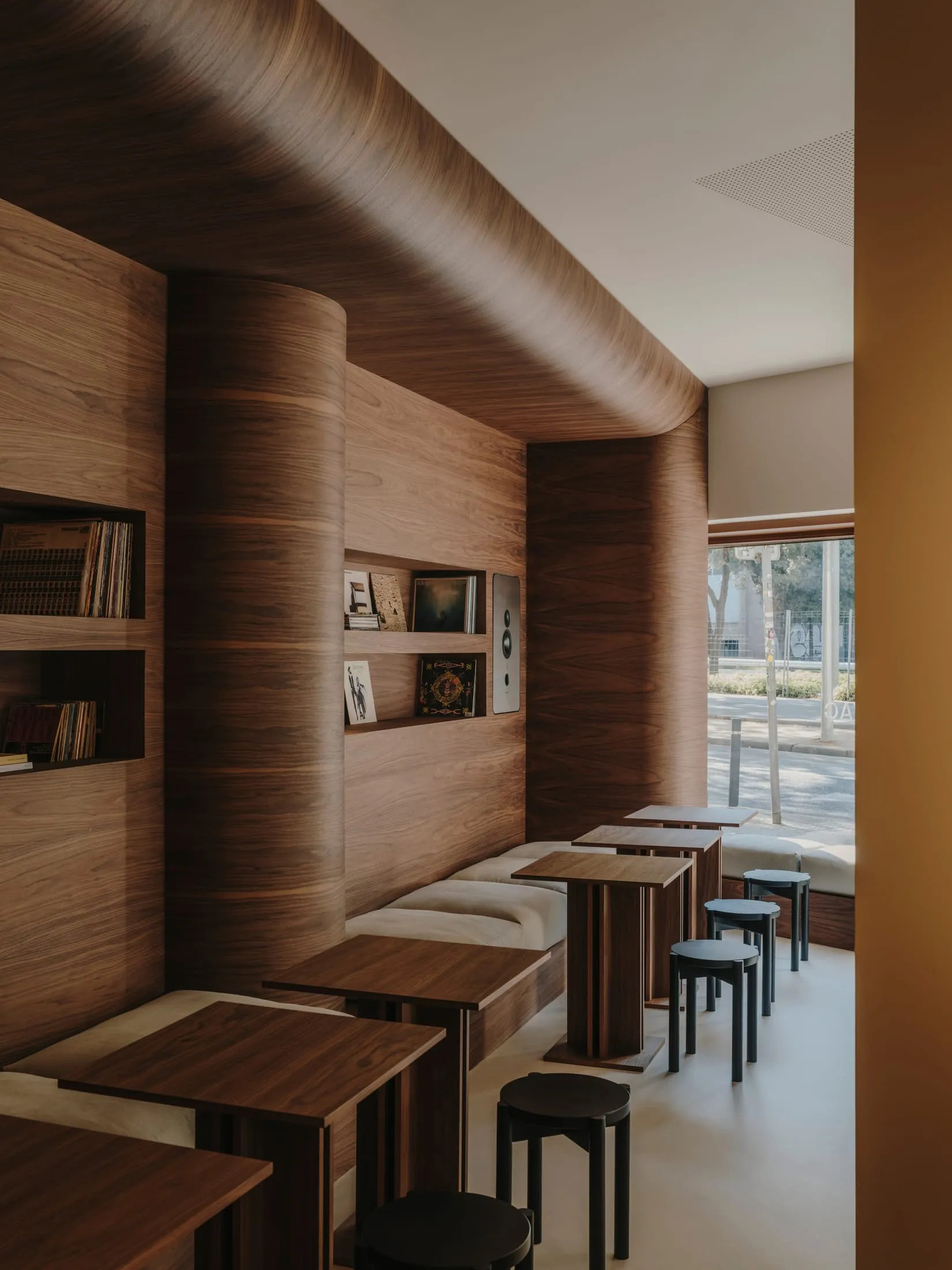 wooden restaurant with tables and chairs, natural light, and a warm atmosphere