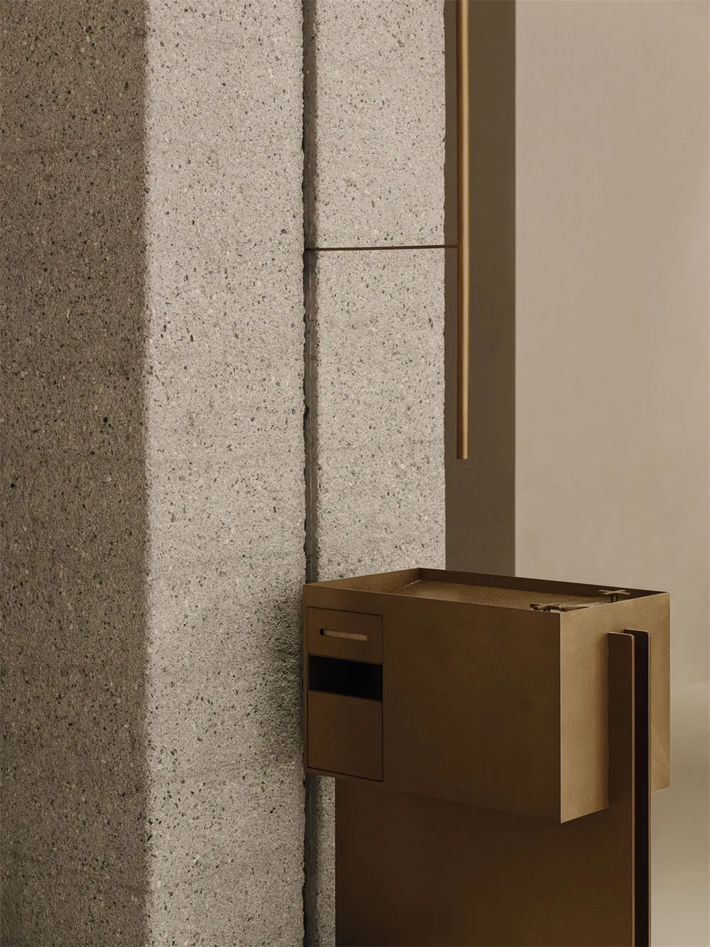 Cozy room with a large stone wall, wooden accents, and a brown box on the floor, lit by dim lighting