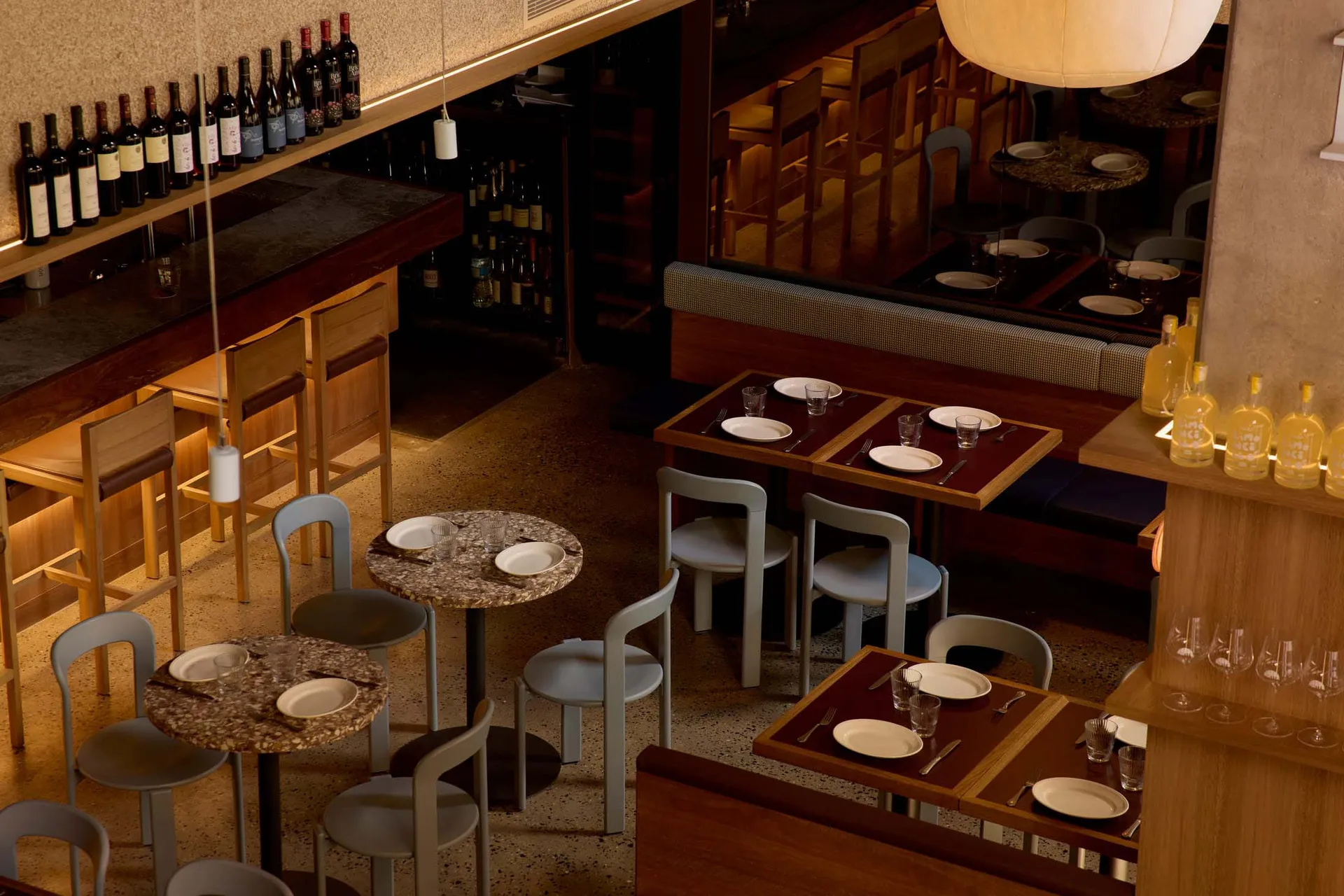 Cozy restaurant interior with wooden furniture, white plates, and dim lighting