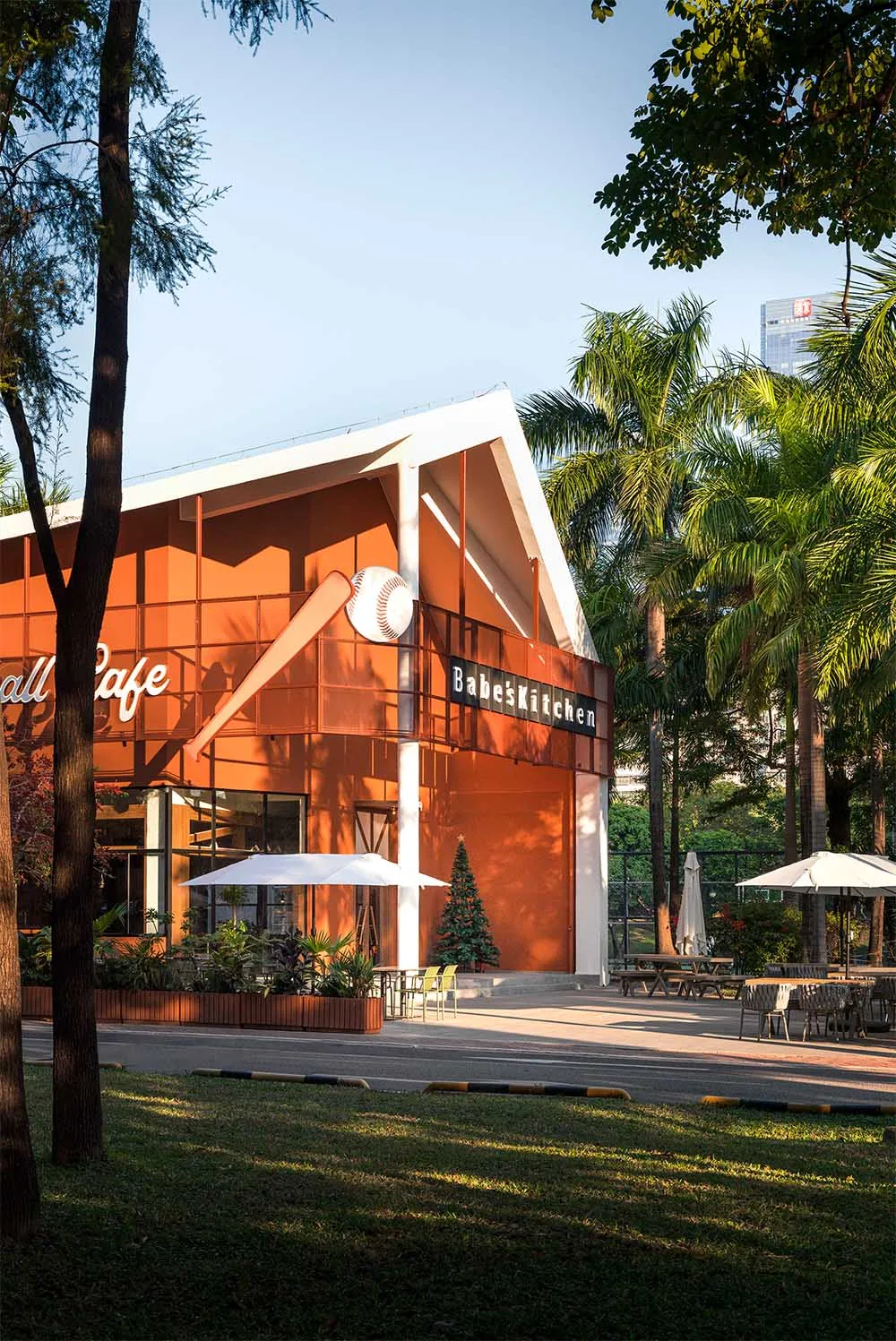 Casual outdoor restaurant with a patio area, wooden furniture, and metal accents, surrounded by a warm and inviting atmosphere