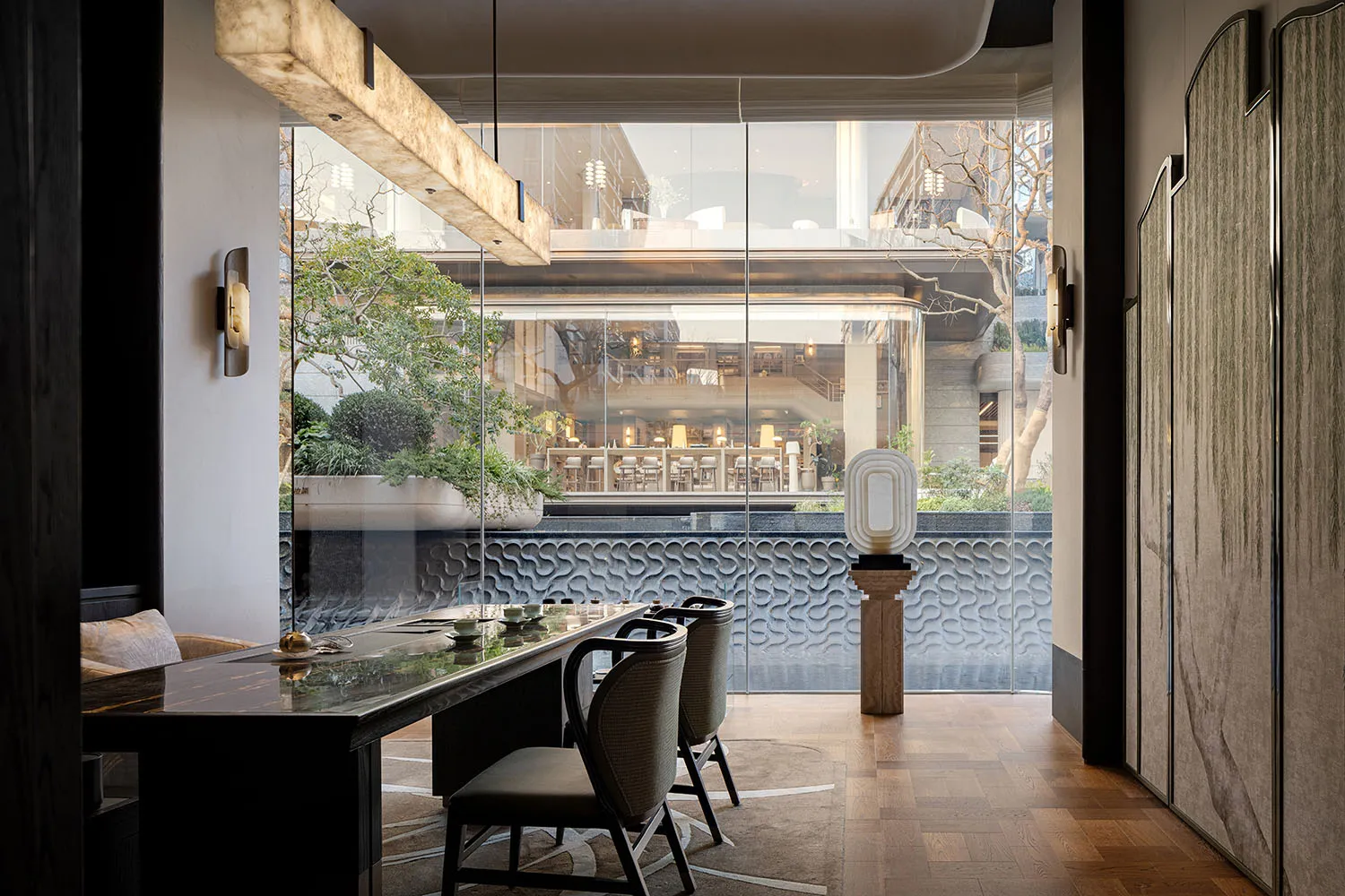 A modern restaurant with a large window, a dining table, chairs, and various table settings, set in a well-lit space with natural light