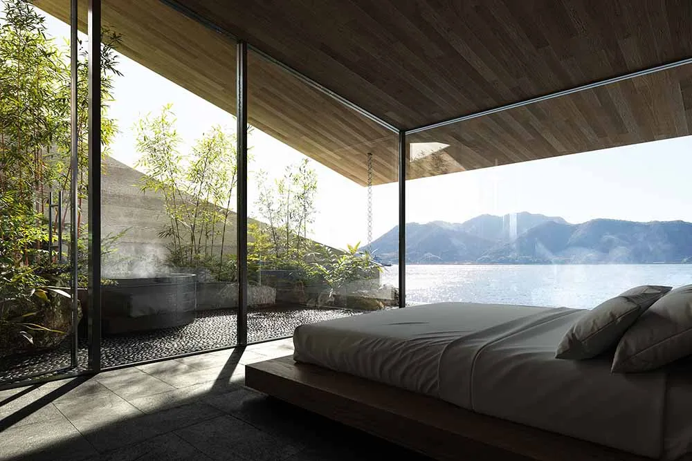 Bright and inviting bedroom with a large bed, natural light, and a view of the outdoors through a large window
