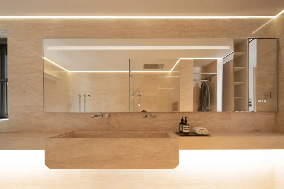 Modern bathroom with a large wooden sink and mirror, well-lit with a clean and inviting atmosphere