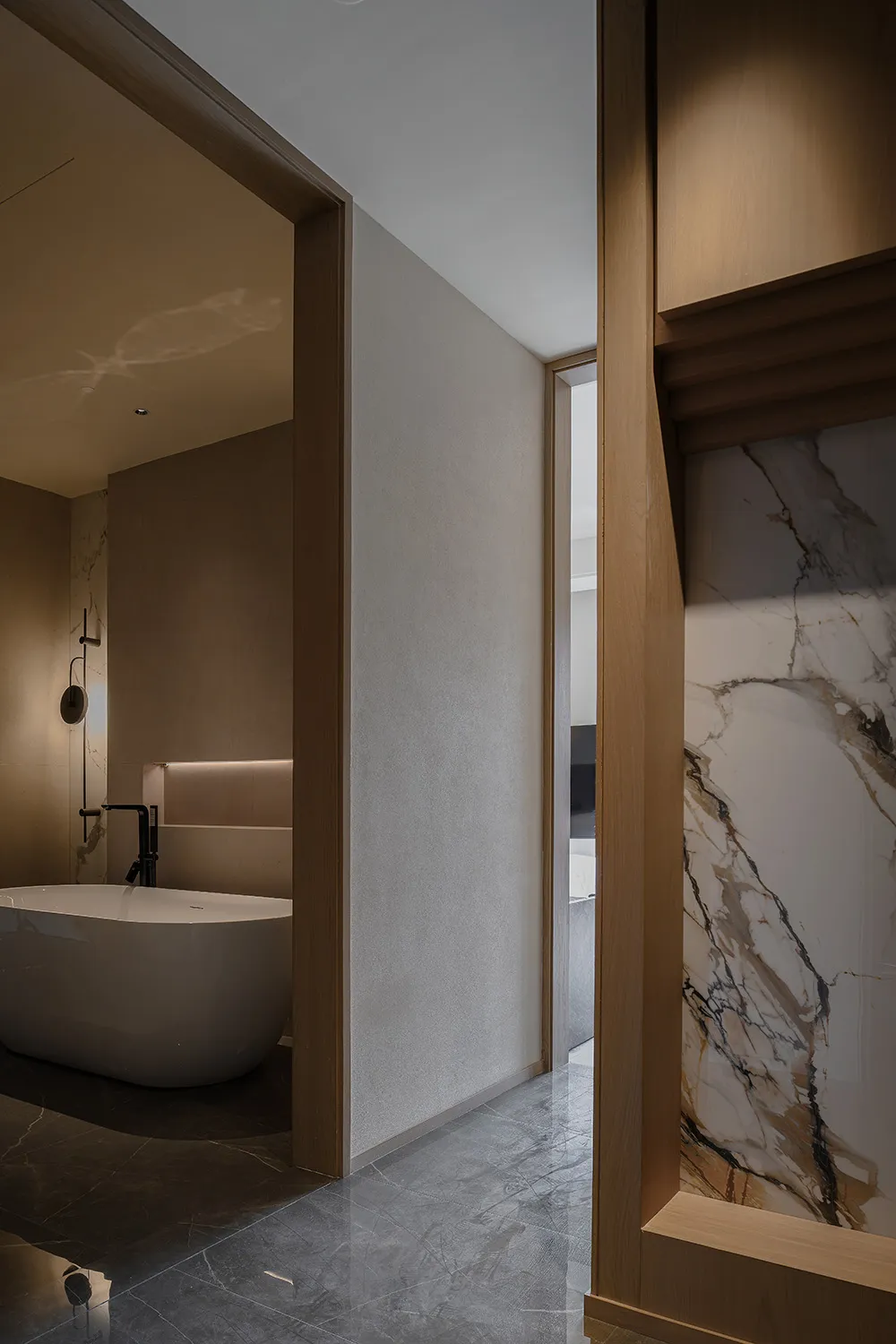 Cozy bathroom with a white bathtub, wooden door, and marble countertop, set against a dimly lit background