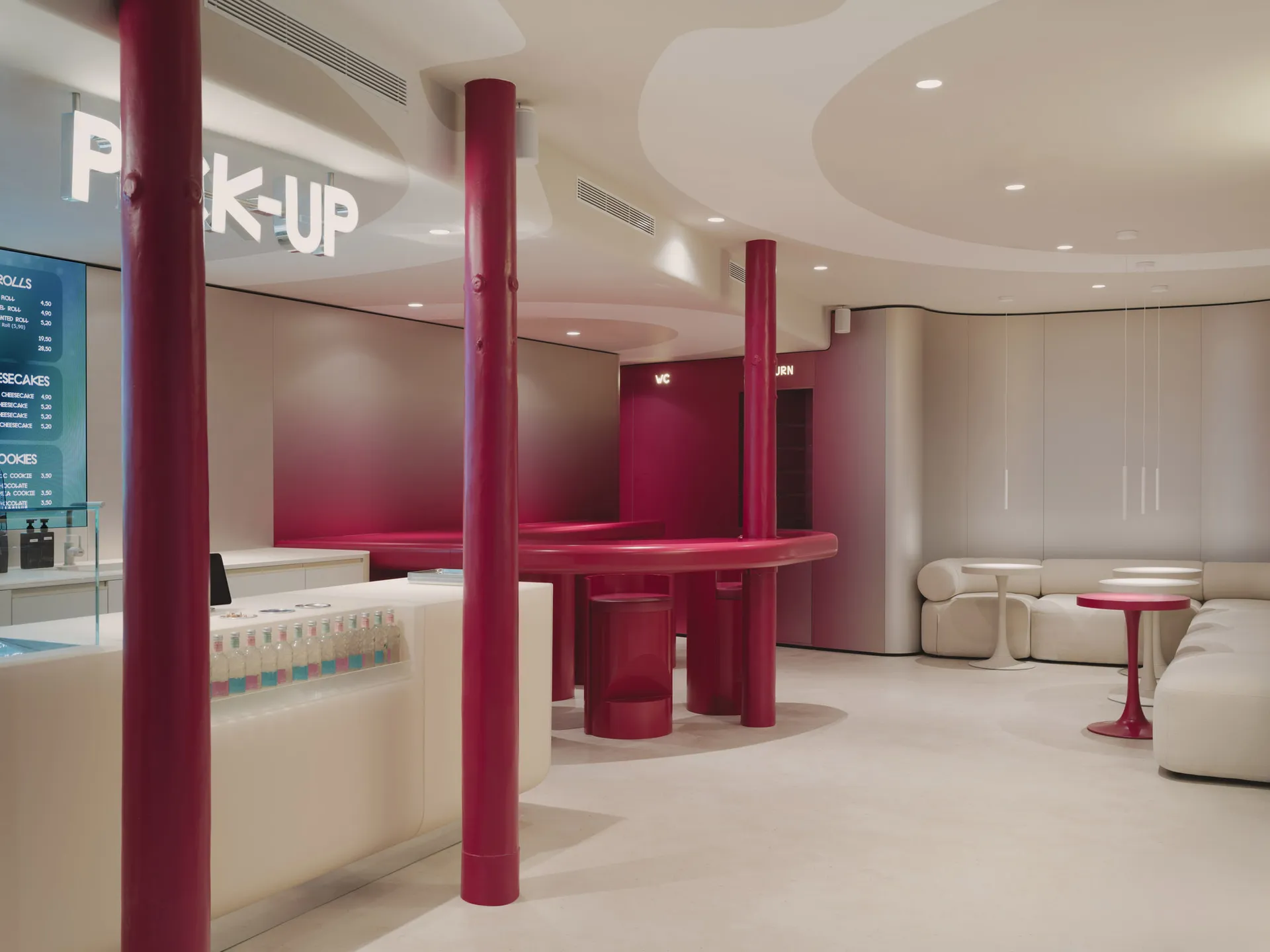 Warm and inviting restaurant with a red counter, table, and chairs, set against a white background