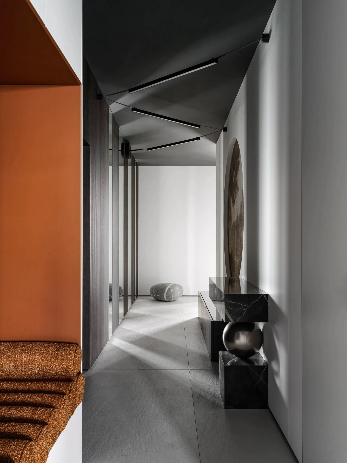 A bright and welcoming hallway with a white wall, brown floor, a bench, a table, and a few balls, in a modern style with clean lines and minimalistic design elements