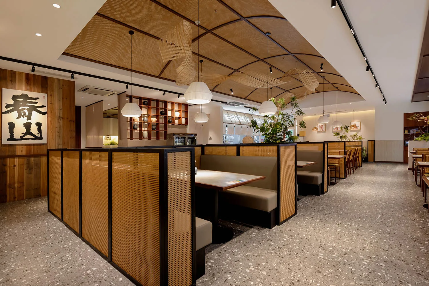 Cozy modern dining space with wooden walls, potted plants, and dim lighting