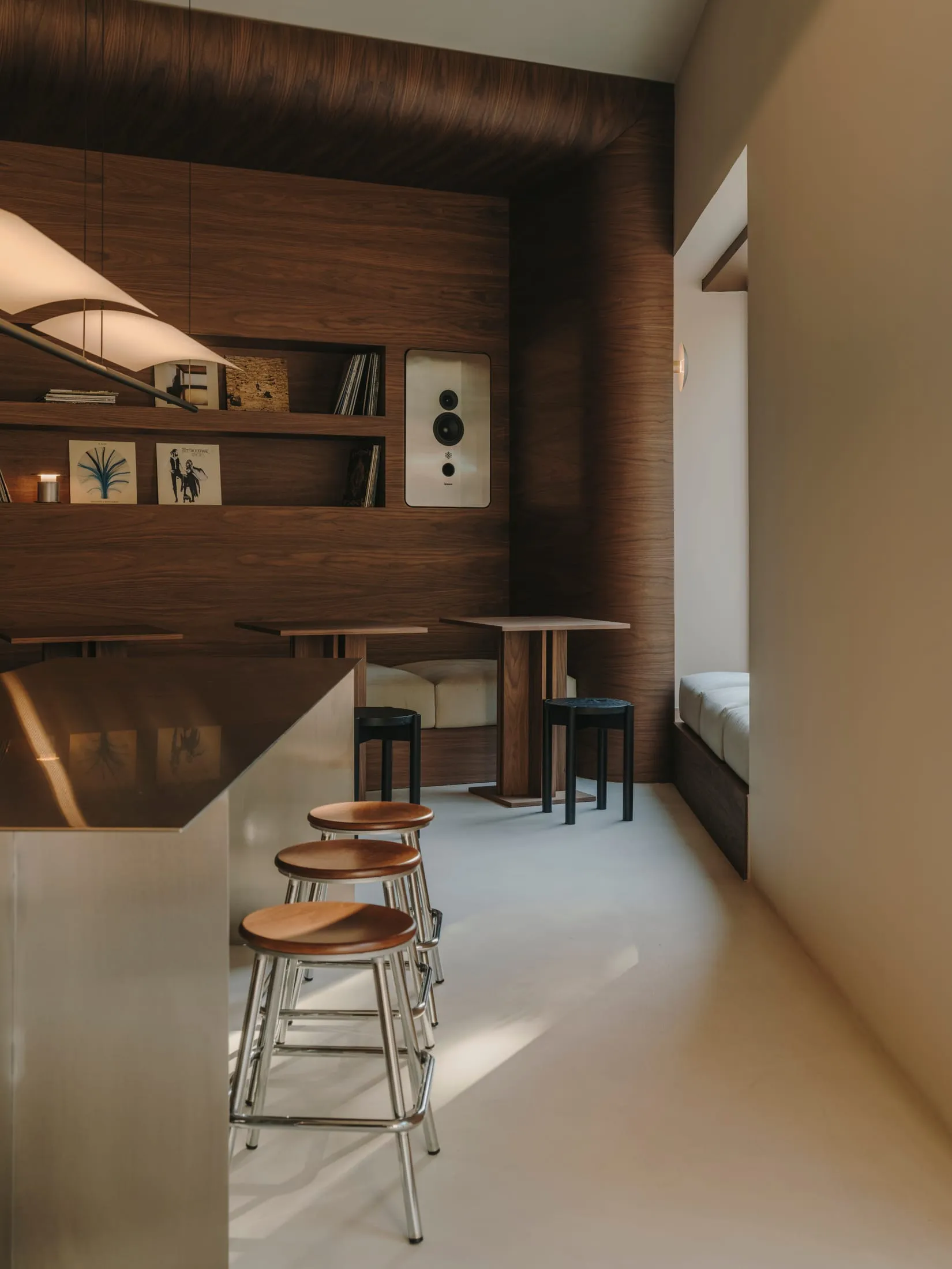 Warm and inviting kitchen with wooden floors and walls, featuring a dining table, counter, and cozy seating area