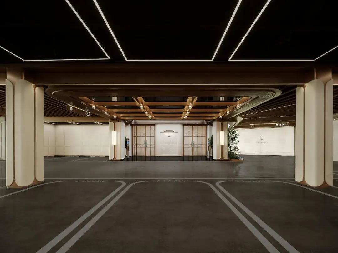 Spacious modern lobby with high ceiling, wooden elements, and a mix of natural and artificial lighting