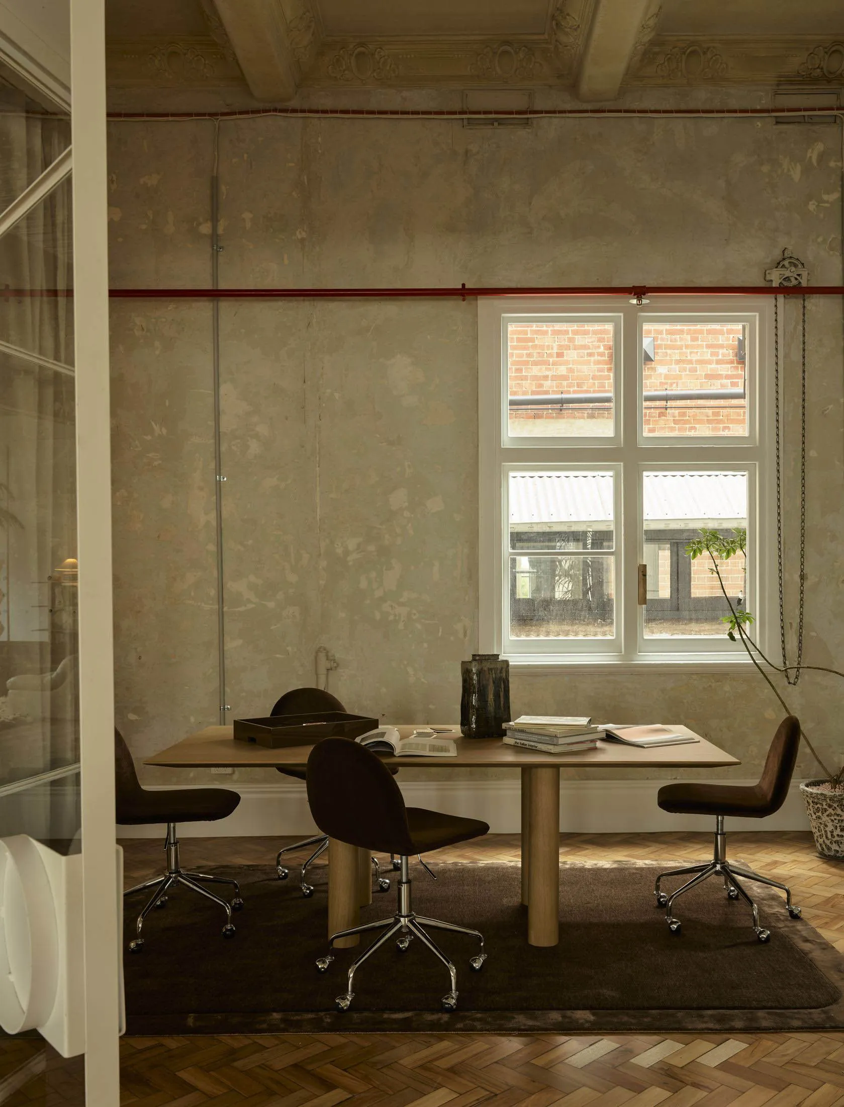 A cozy room with a wooden table and chairs, natural light from a window, and a warm atmosphere