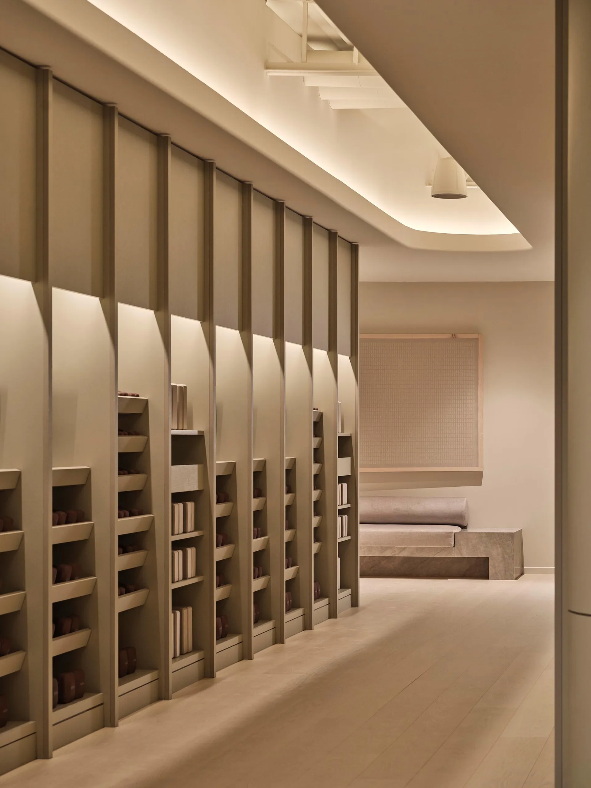 A study area with a large wooden bookshelf filled with books, creating a cozy and intellectual atmosphere